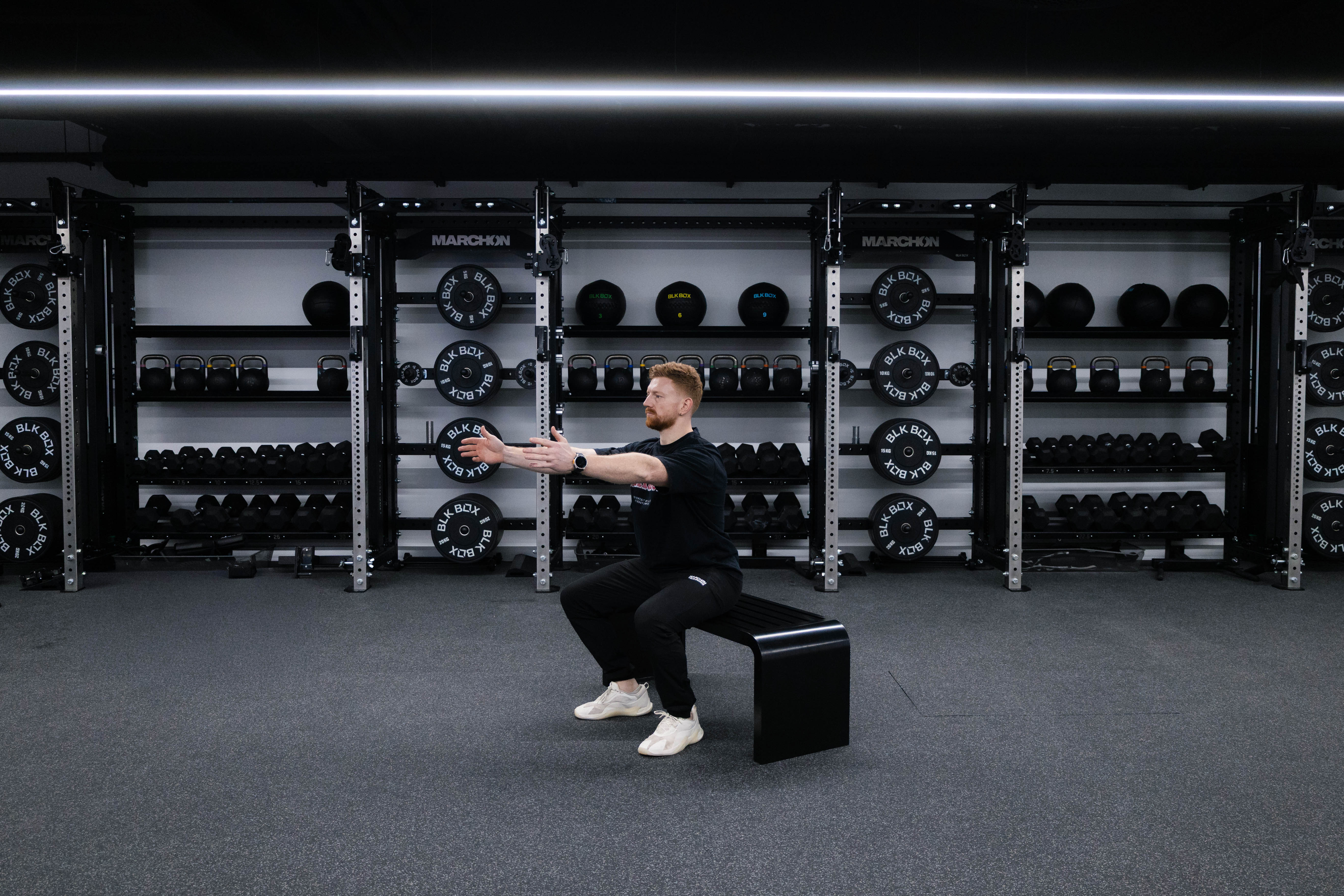 Marchon coach Patrick James demonstrates how to perform a squat to box