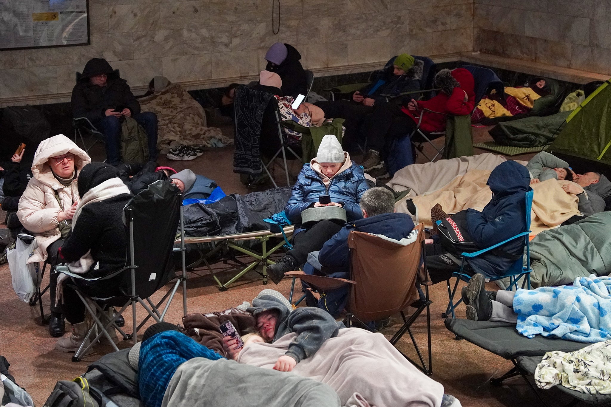 People take shelter in a metro station during a Russian air attack in Kyiv