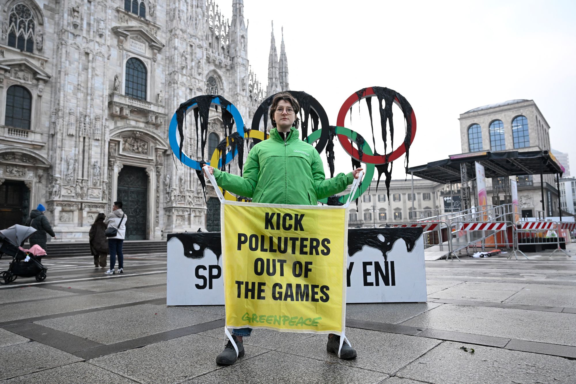 Greenpeace stages Winter Olympics protest as torch arrives in Milan