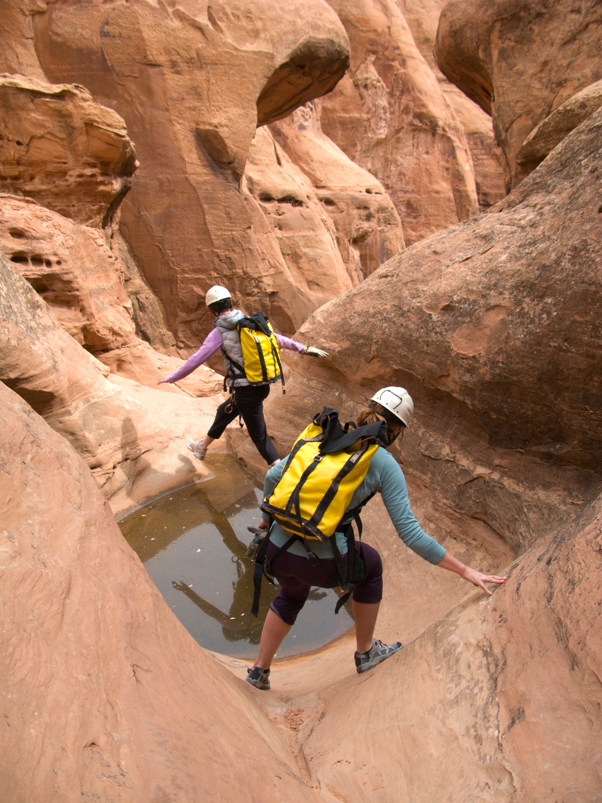 Two hikers are pictured here negotiating a canyon in Utah