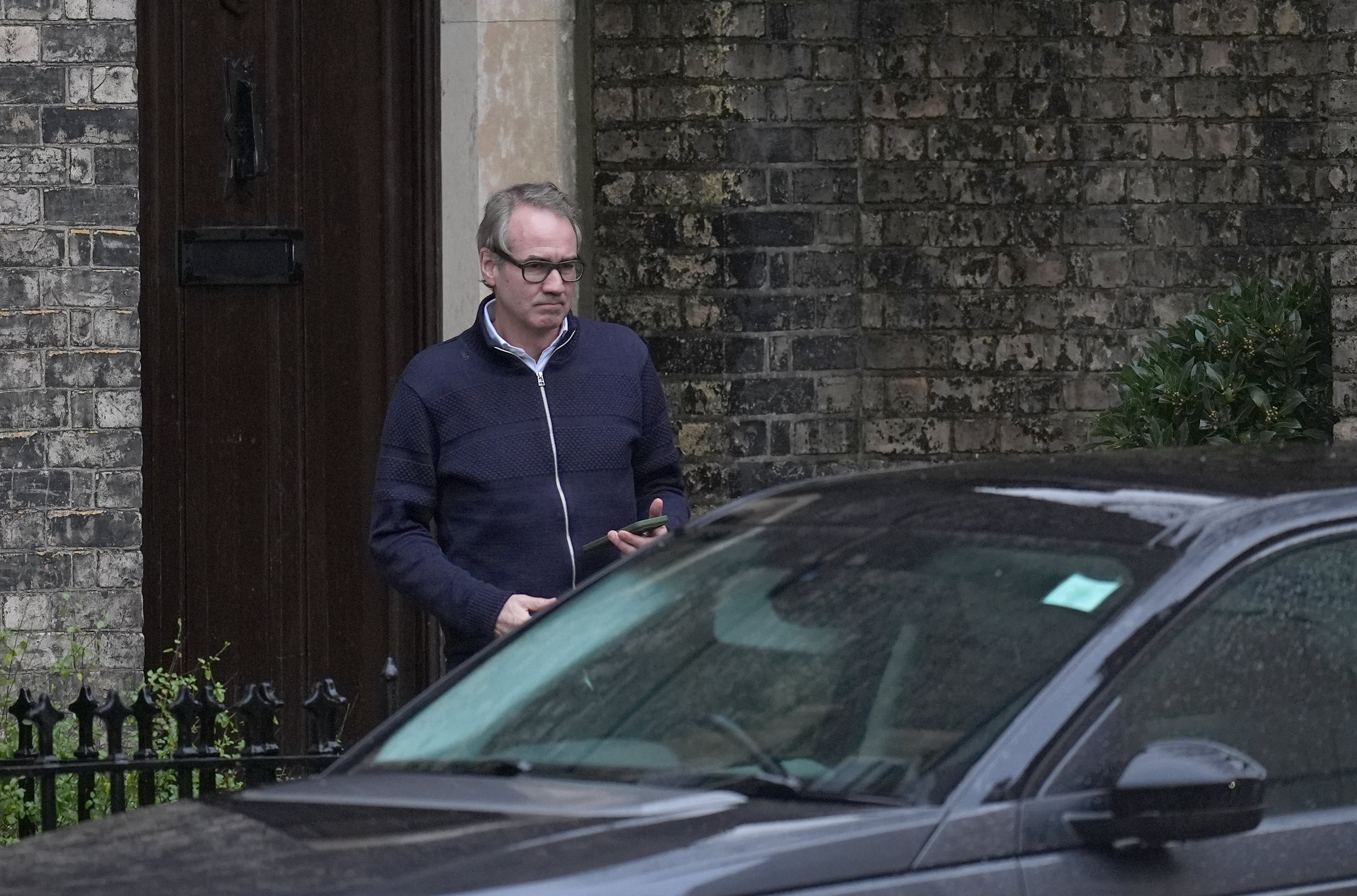 An unidentified man outside the home of Lord Peter Mandelson in north west London