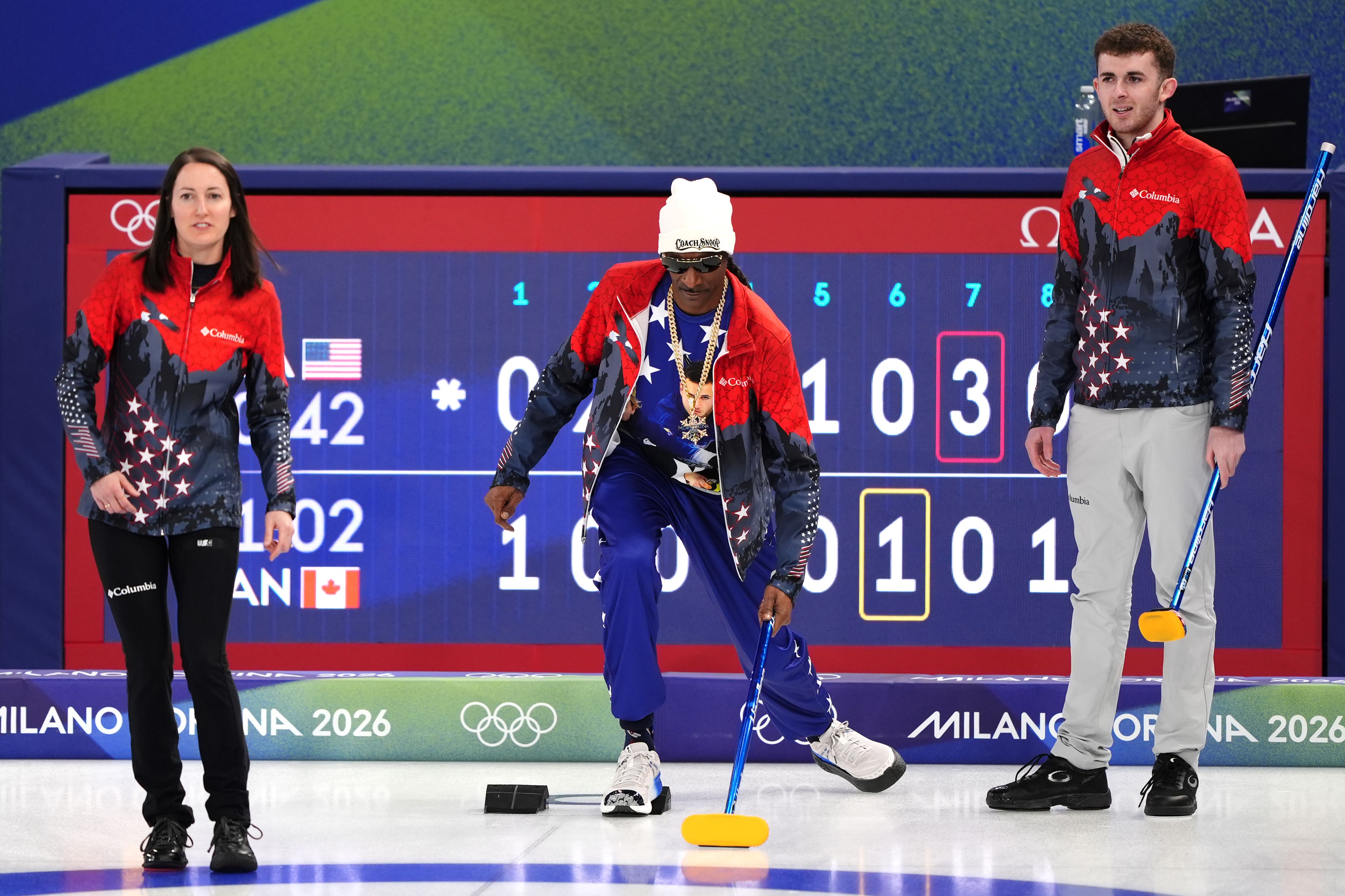 American rapper Snoop Dogg (centre) practices curling with the USA Curling team at the Cortina Curling Olympic Stadium (Andrew Milligan/PA)