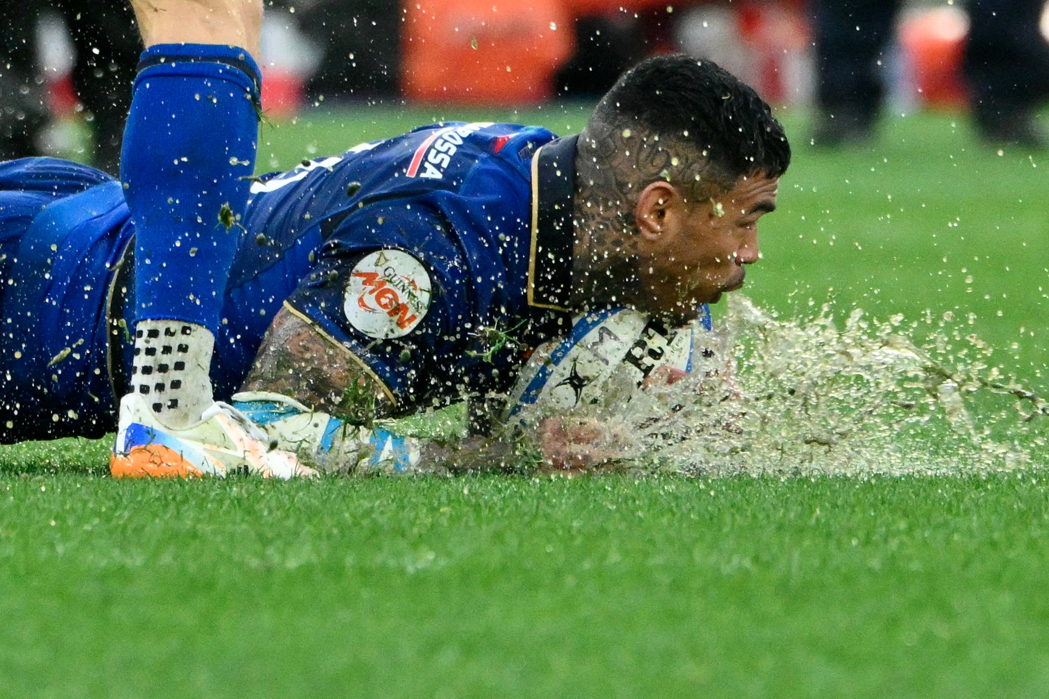 Italy's wing Monty Ioane falls with the ball during the Six Nations international rugby union match between Italy and Scotland (Photo by Alberto PIZZOLI / AFP via Getty Images)