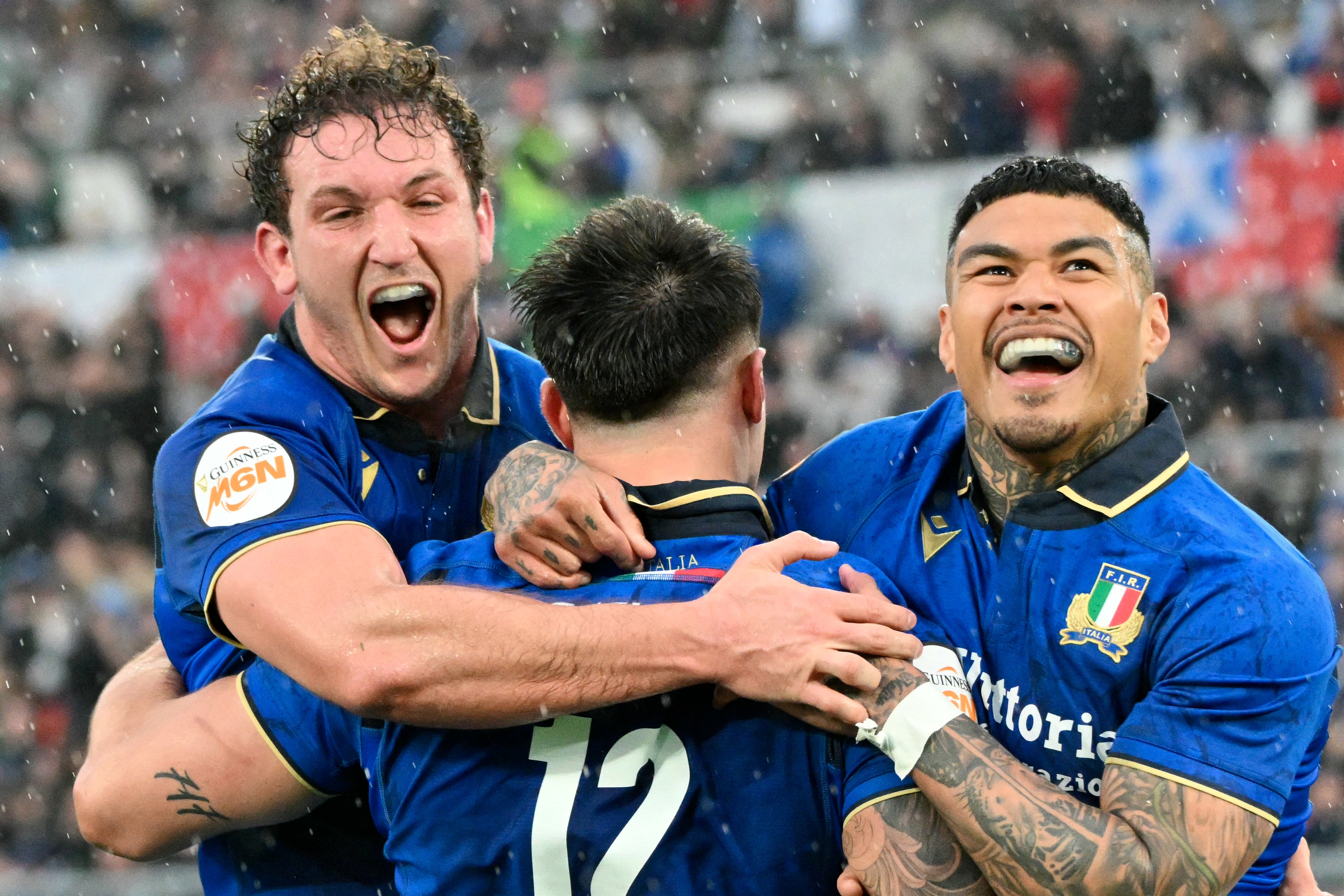 Italy’s Tommaso Menoncello is congratulated by teammates after scoring a try during the Six Nations international rugby union match between Italy and Scotland at the Stadio Olimpico, in Rome (Photo by Alberto Pizzoli/AFP/Getty Images)