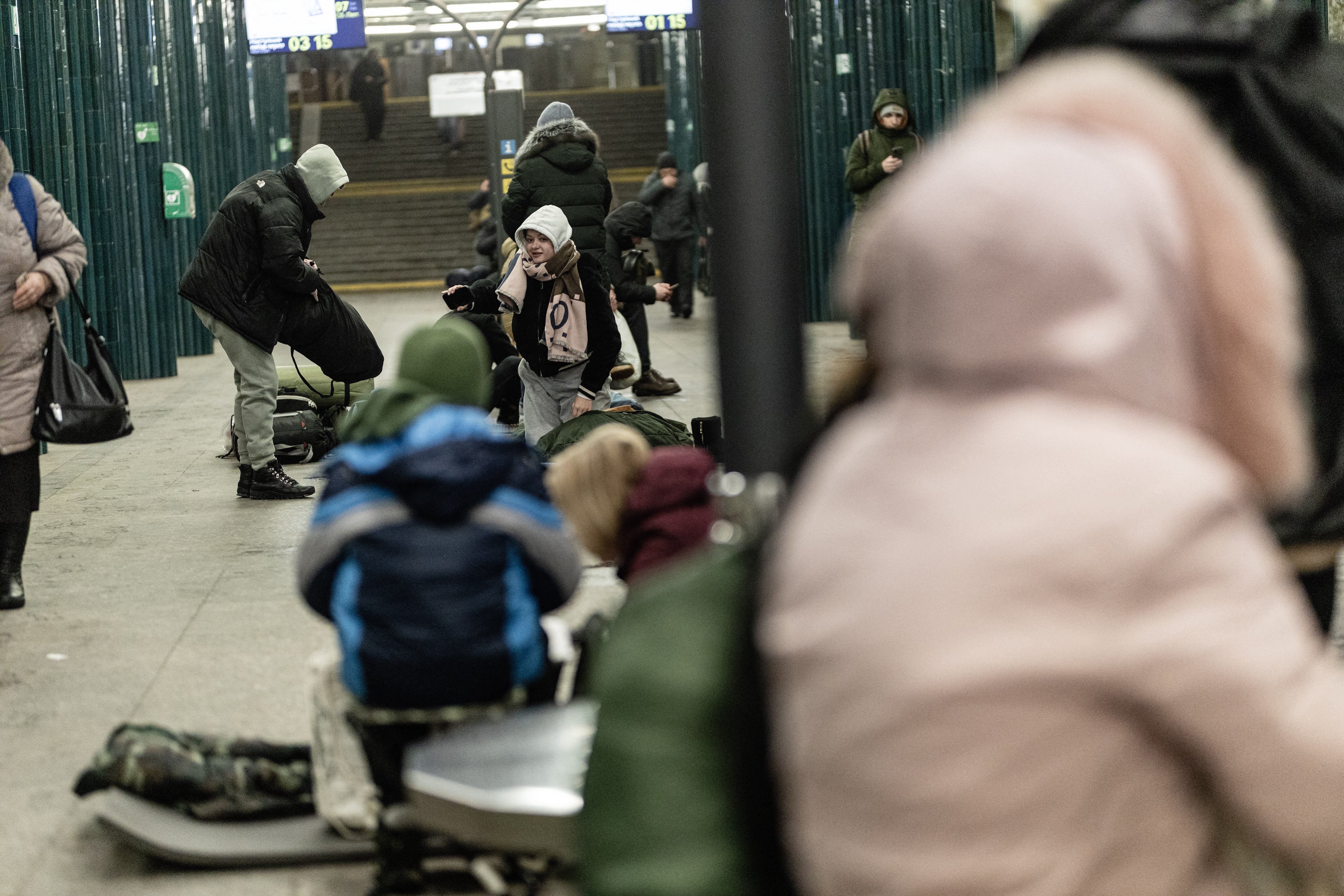 People sit on chairs and benches inside a metro station while taking shelter during the night, in Kyiv, Ukraine on February 7, 2026. Residents gathered underground with blankets, sleeping bags, and makeshift bedding to stay safe during nighttime air attacks on the city. (Photo by Daniel Yovkov / Hans Lucas / AFP via Getty Images)