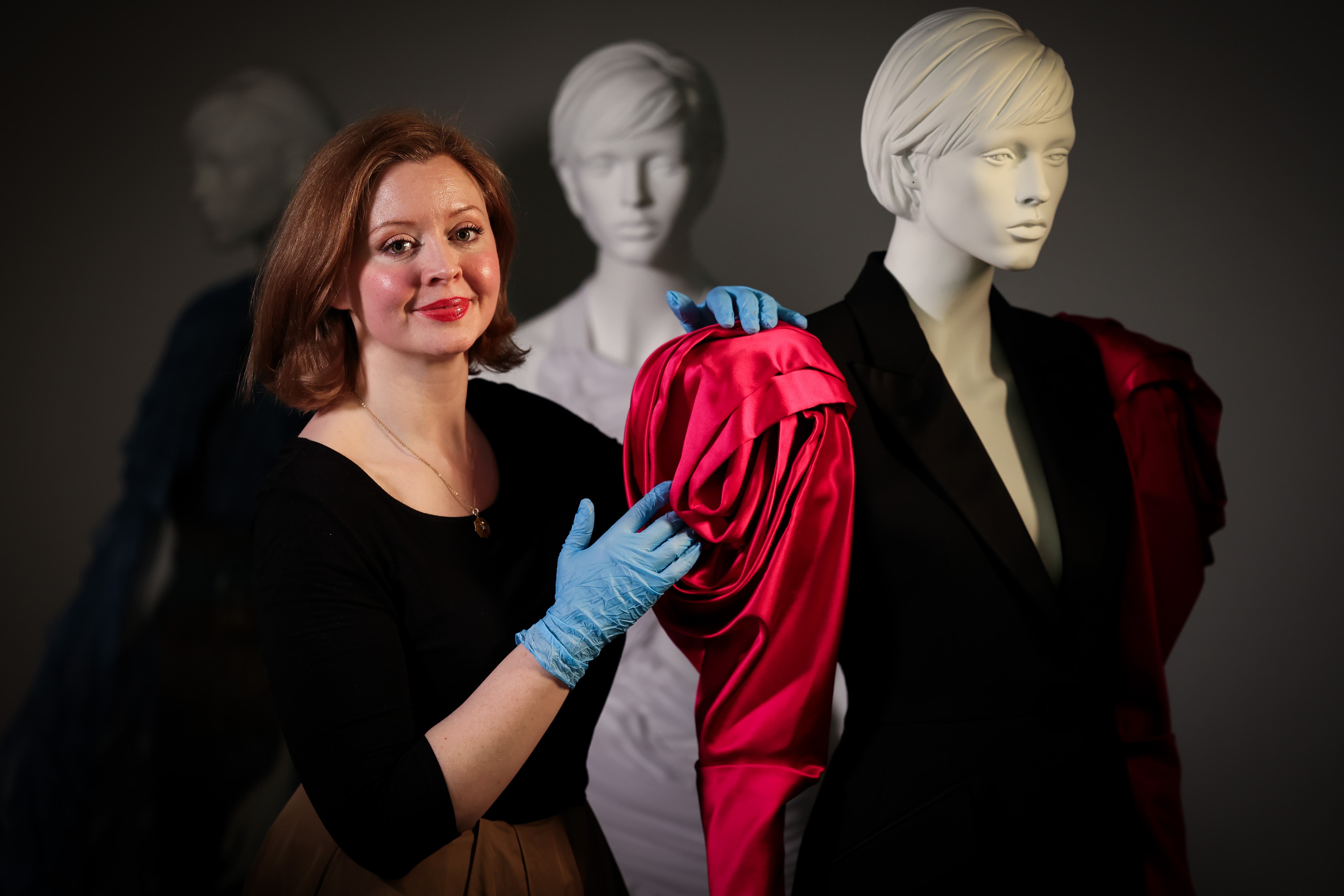 Charlotte McReynolds, curator of art at National Museums NI, putting the final touches to the Ashes to Fashion exhibition at the Ulster Museum (Press Eye/PA)
