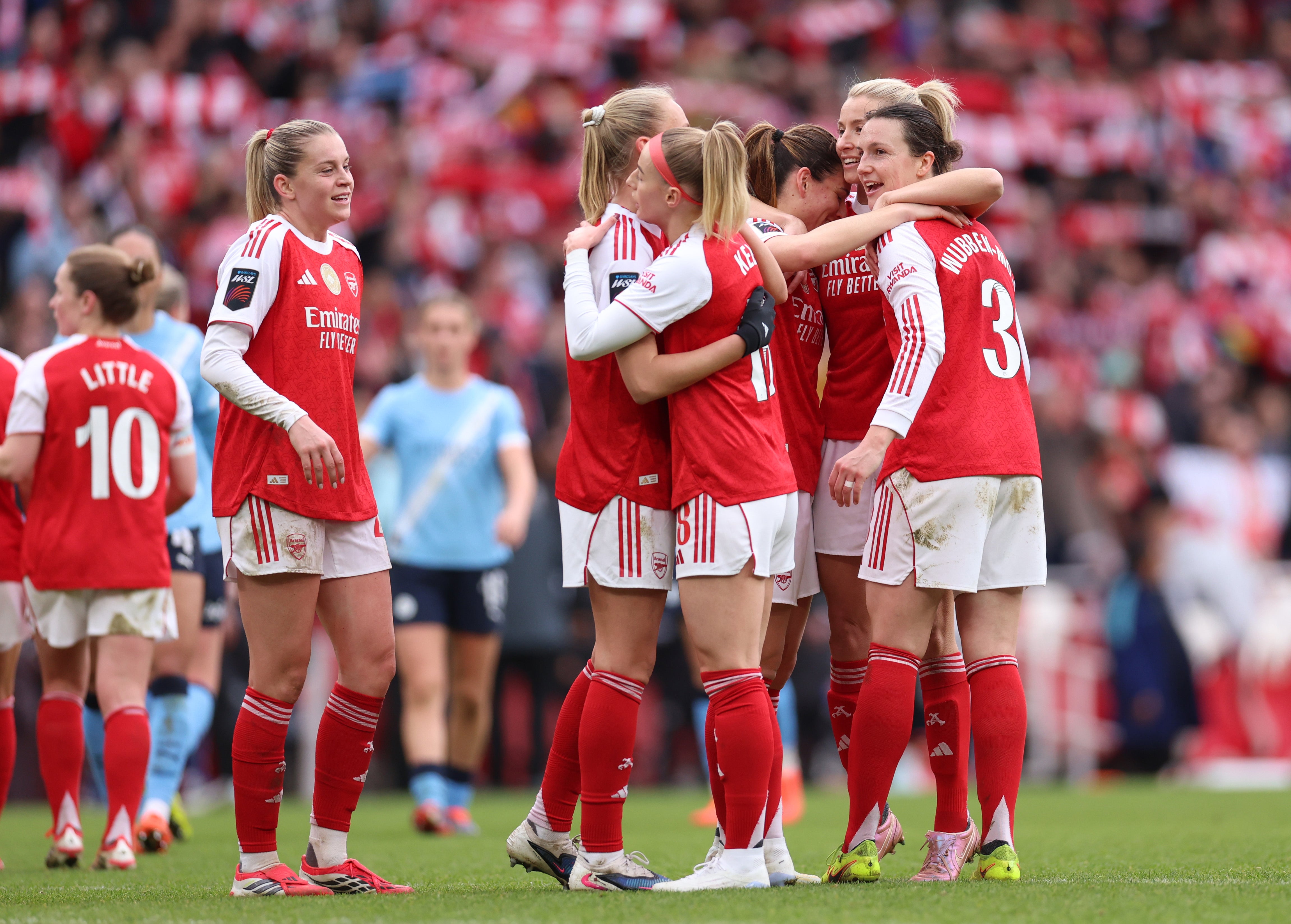 Arsenal players celebrate following the team's victory in the Barclays Women's Super League match between Arsenal and Manchester City