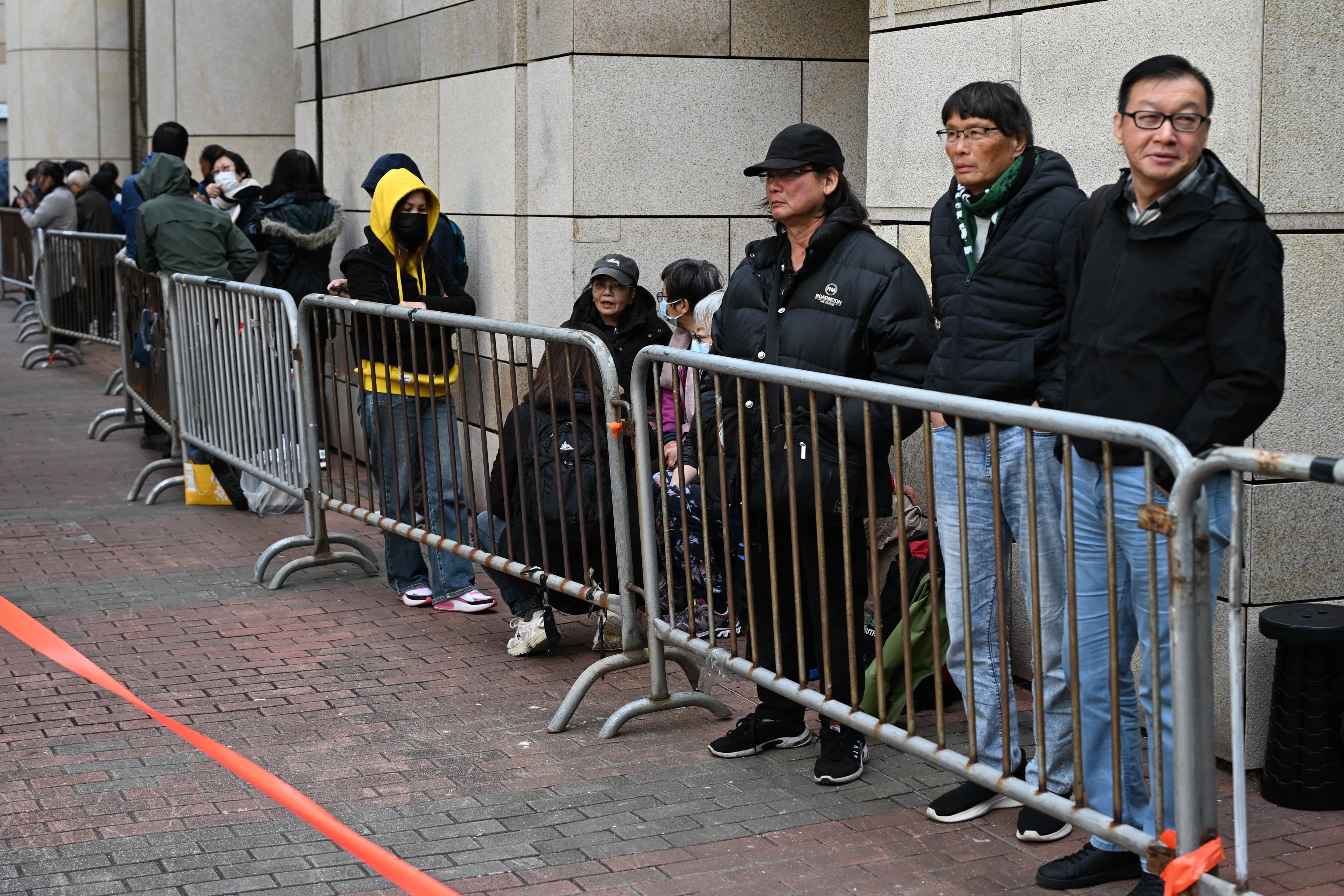 People queue outside the West Kowloon Magistrates' court in Hong Kong