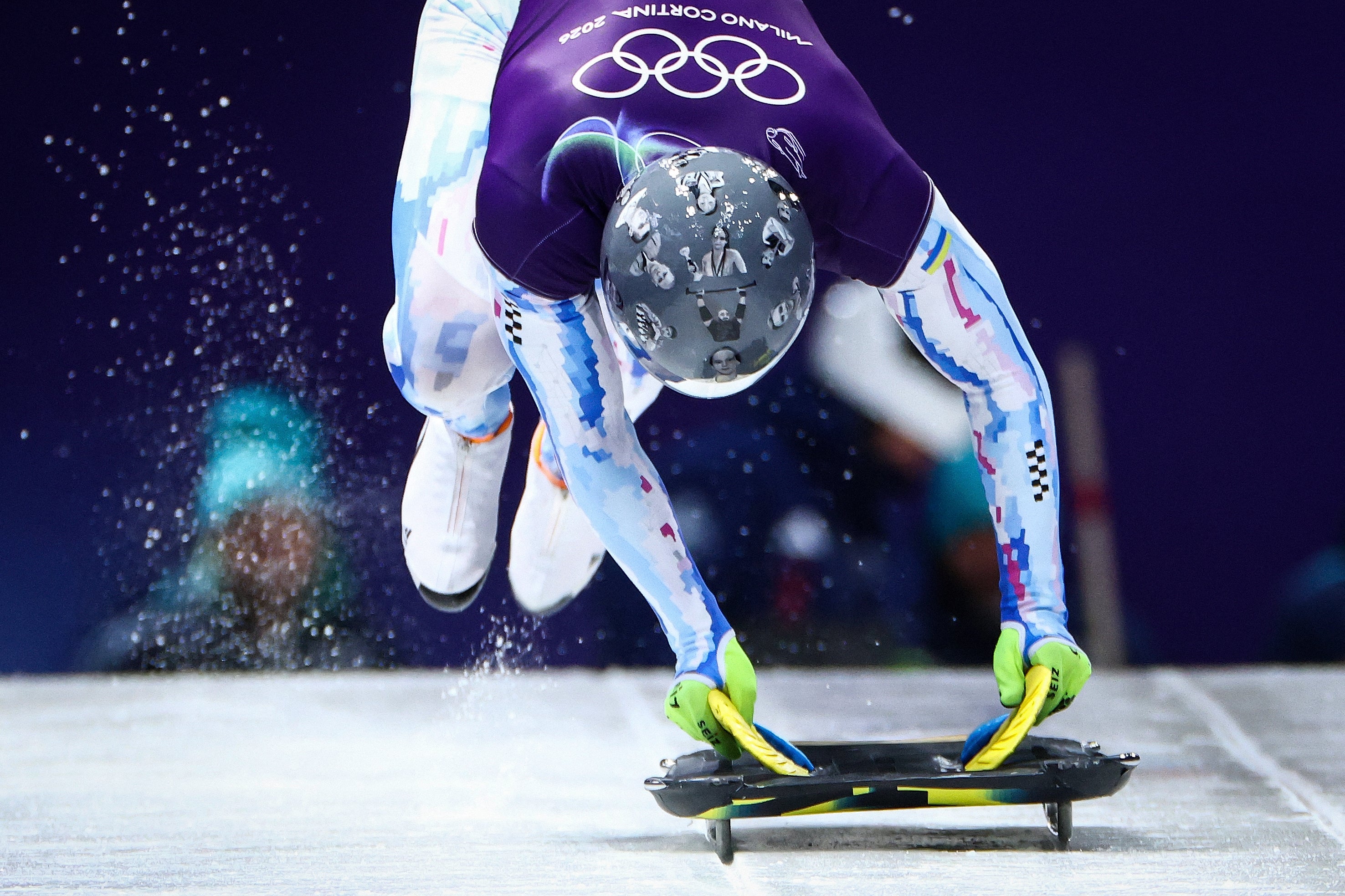 Vladyslav Heraskevych trains wearing a helmet honouring athletes and friends lost in the war