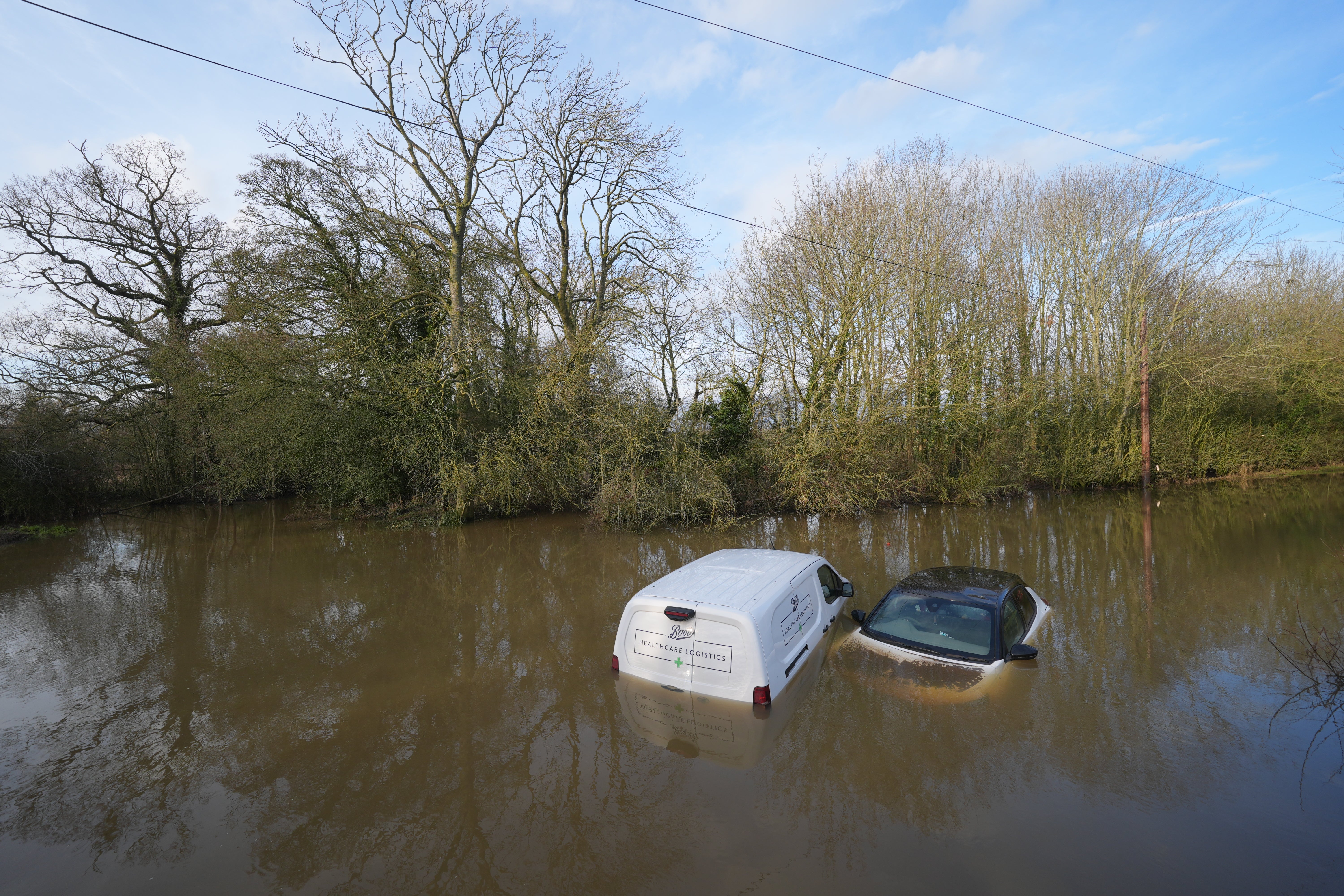 Vehicles left abandoned in a flooded ford in Leicestershire (Joe Giddens/PA)