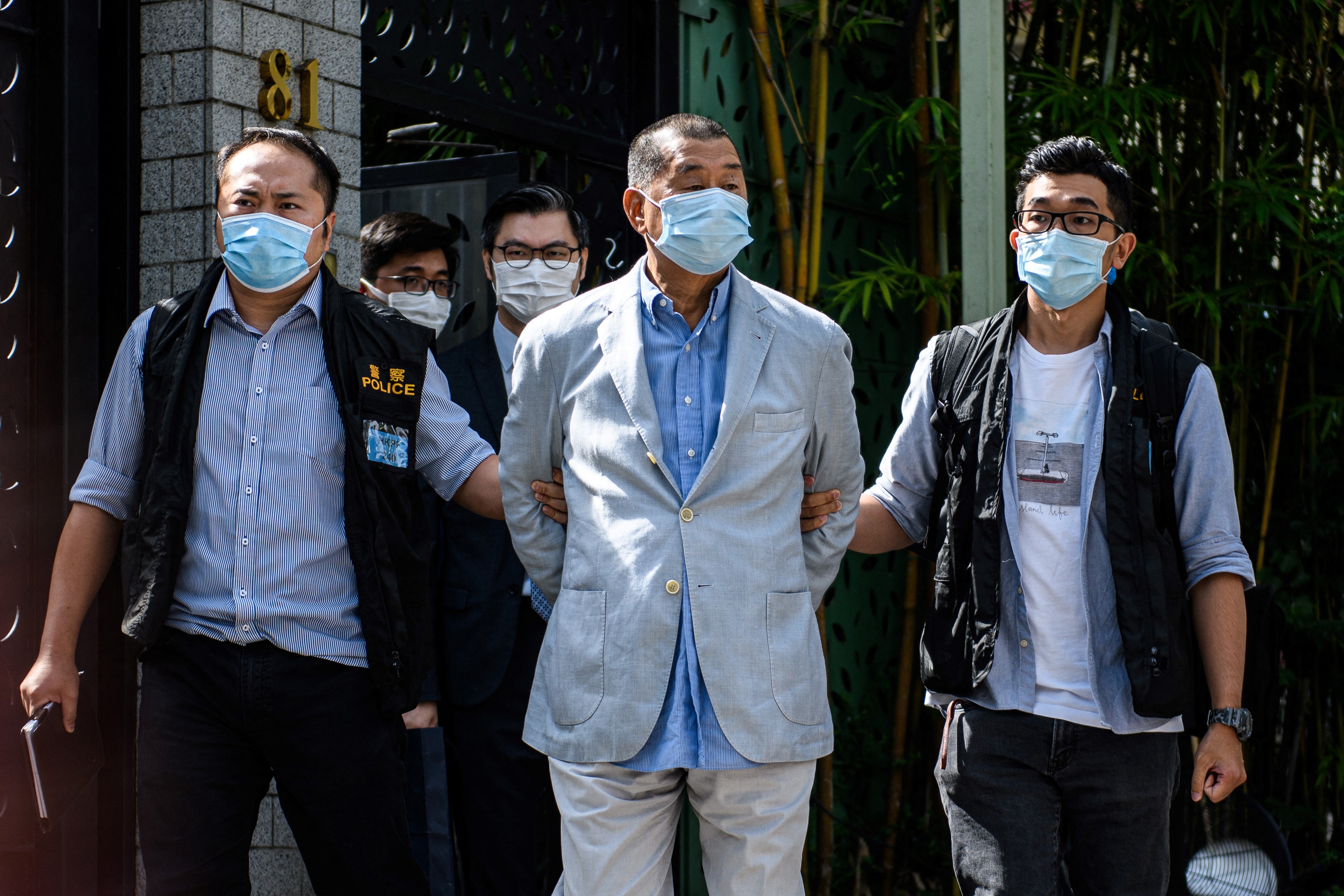 File: Police lead Hong kong pro-democracy media mogul Jimmy Lai (C) away from his home after he was arrested under the new national security law in Hong kong on August 10, 2020