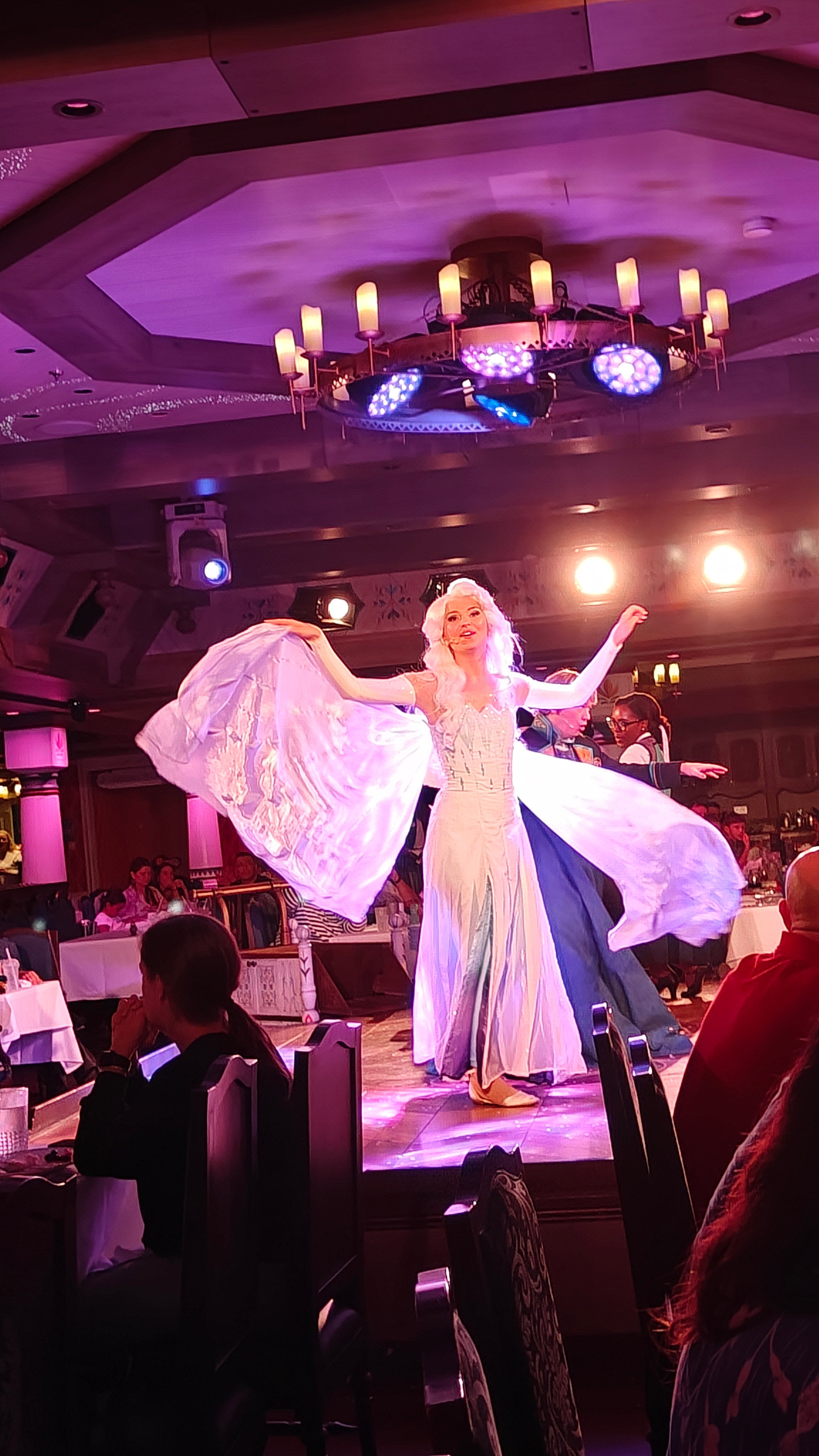 Elsa entertains the crowds during an immersive Frozen-themed dinner aboard Disney Wish