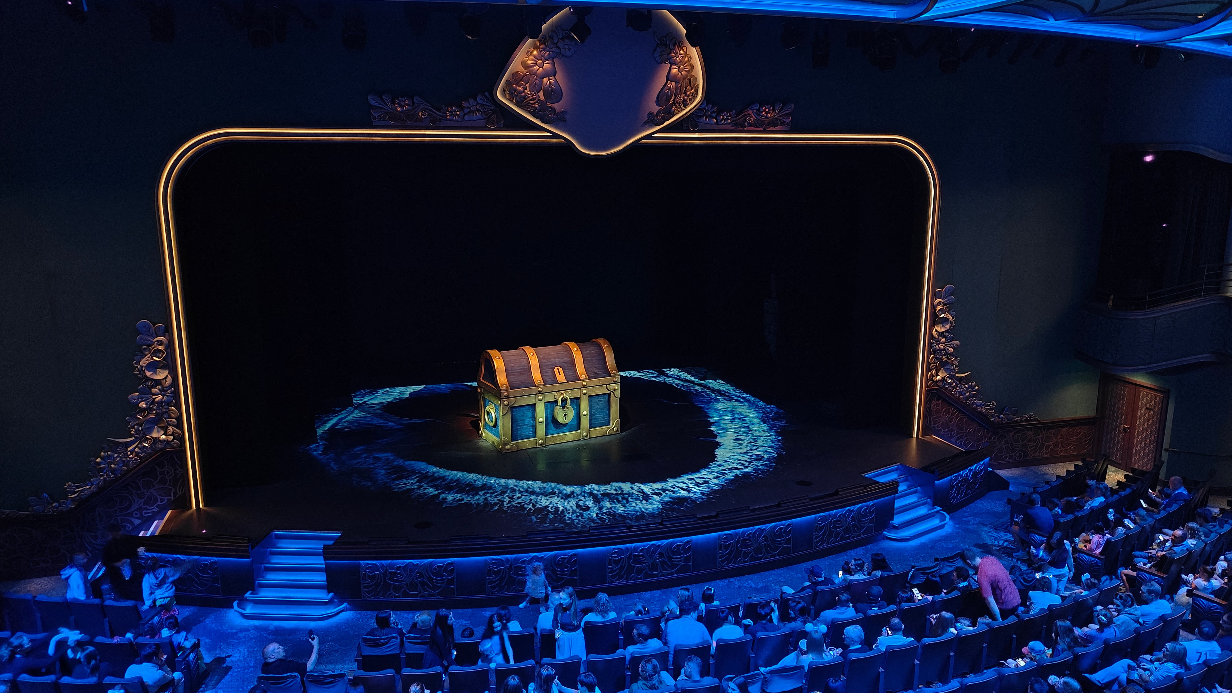 A giant treasure chest dominates the stage ahead of the Little Mermaid show in the Walt Disney Theatre aboard Disney Wish