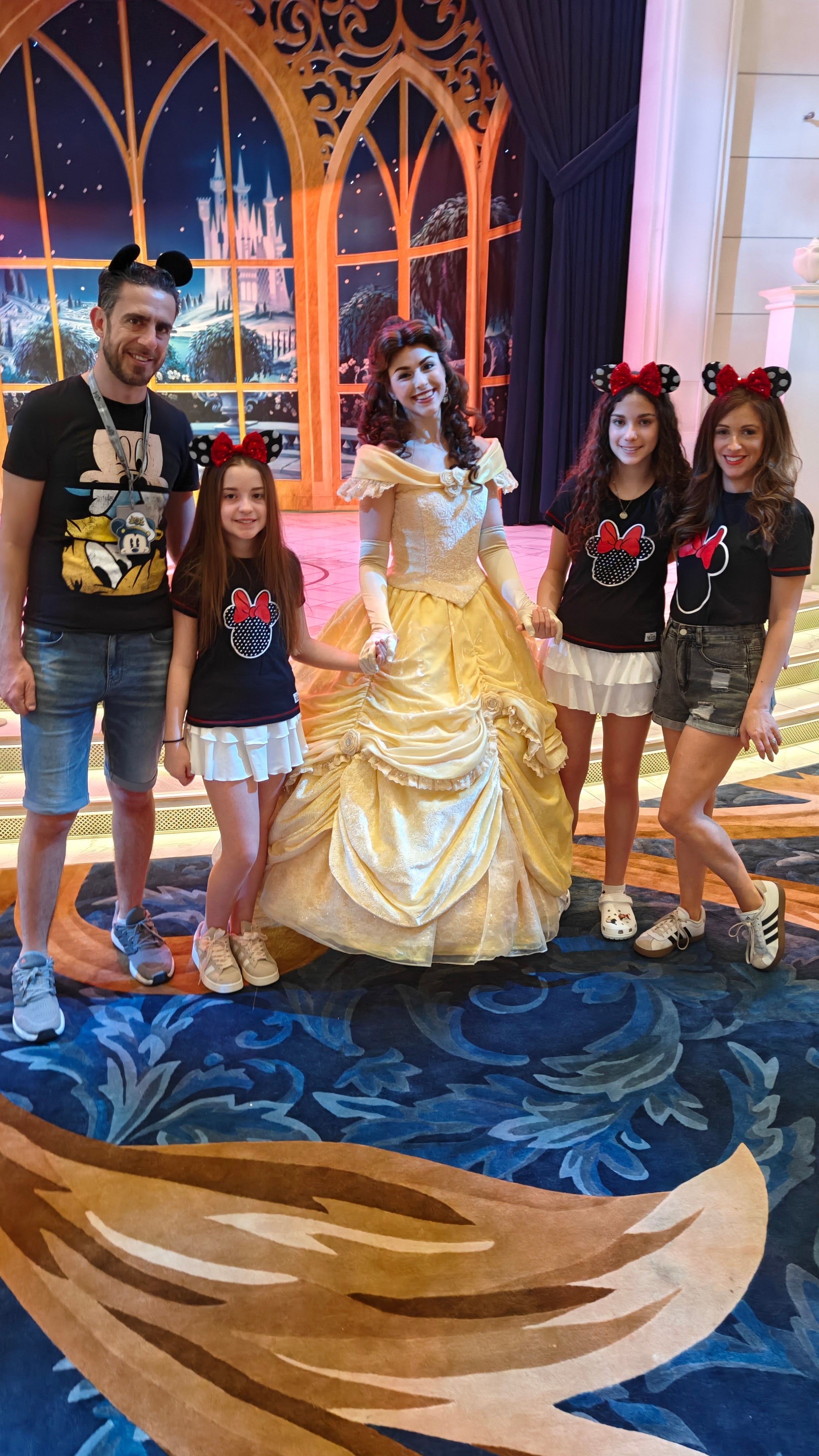 The Shoffmans pose with Belle aboard Disney Wish