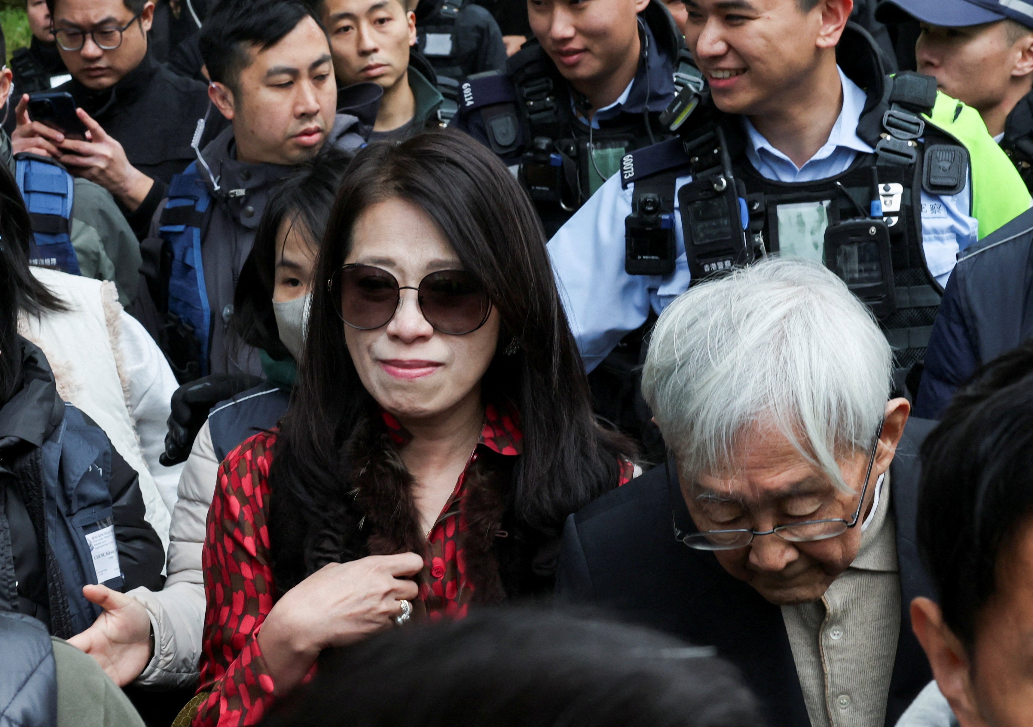 Retired bishop Cardinal Joseph Zen Ze-kiun and Teresa Lai, wife of Jimmy Lai, leave West Kowloon Magistrates' Courts building after Jimmy Lai, founder of the now-defunct pro-democracy newspaper Apple Daily, was sentenced a total of 20 years in jail on three charges comprising two counts of conspiracy to collude with foreign forces and one count of publishing seditious materials, in Hong Kong, China