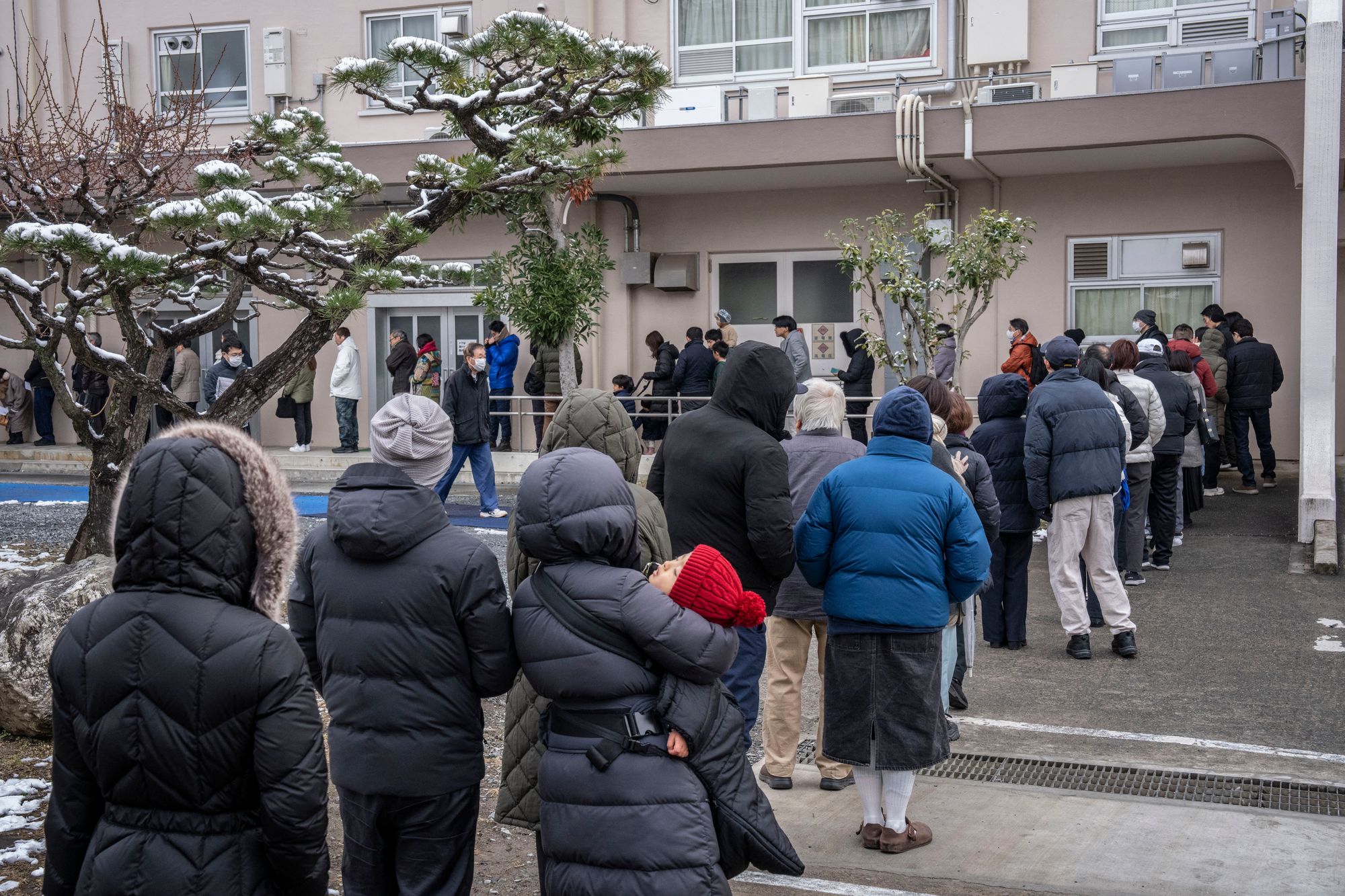 People queue up at a polling station to vote during the House of Representatives election in Kawasaki, Kanagawa prefecture on 8 February 2026