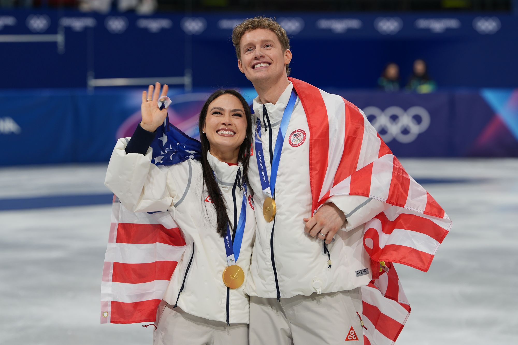 Team USA's Madison Chock and Evan Bates pose with their gold medals after winning the figure skating team event
