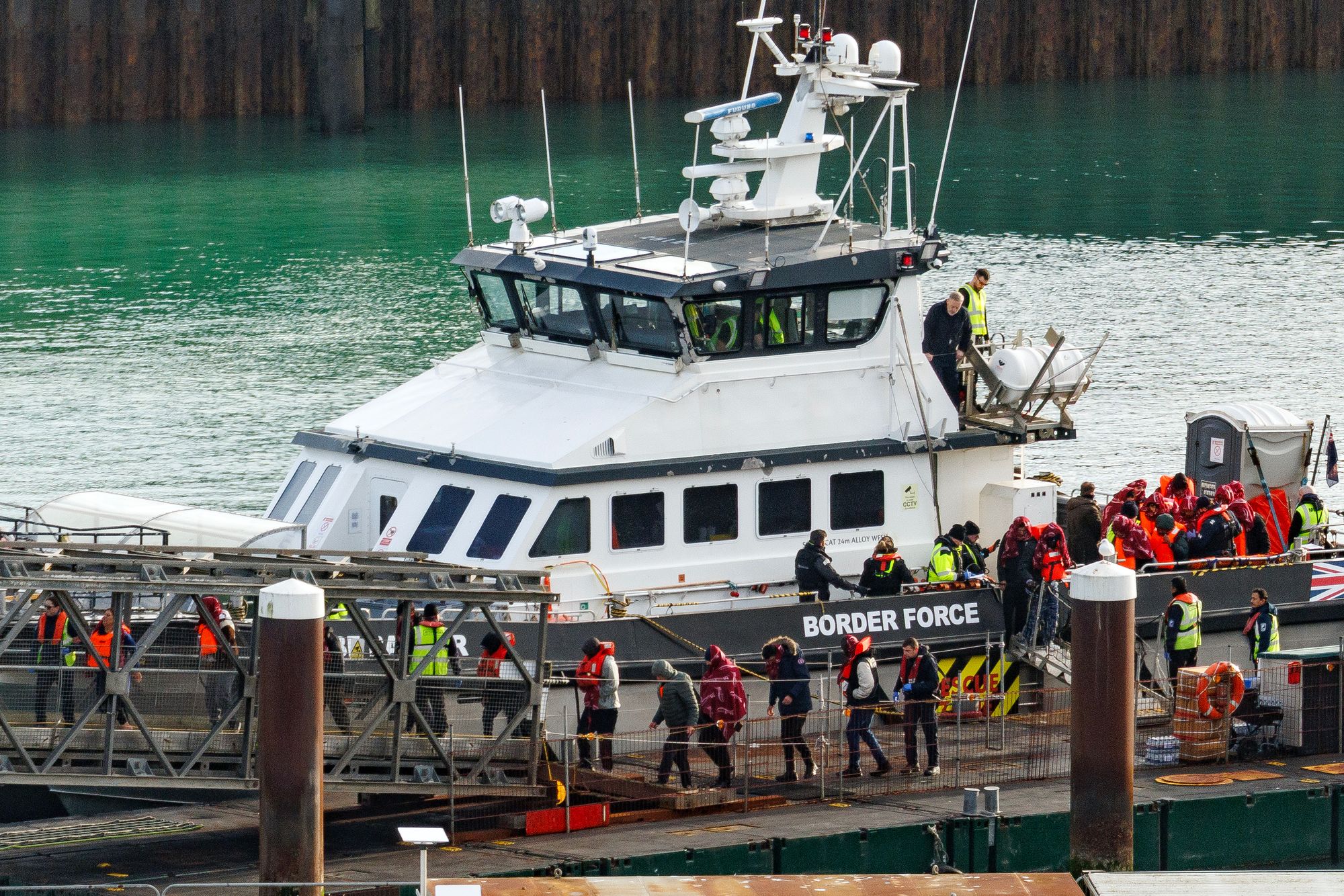 A Border Force vessel delivers migrants to Dover port after intercepting a small boat crossing on December 17, 2025 in Dover, England. Some 305 people who have come to the UK on a small boat have been deported back to France under the one in, one out deal.