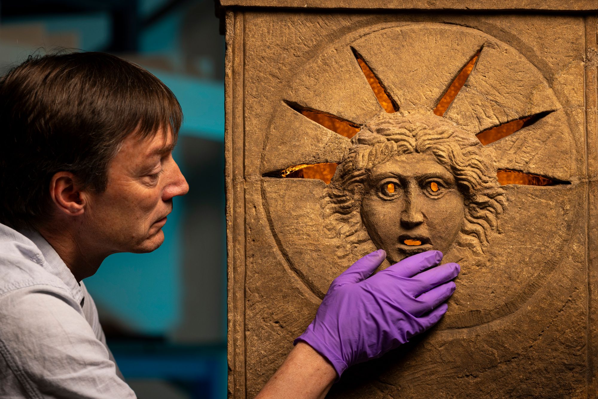 National Museum of Scotland curator Sr Fraser Hunter examining the Roman altars
