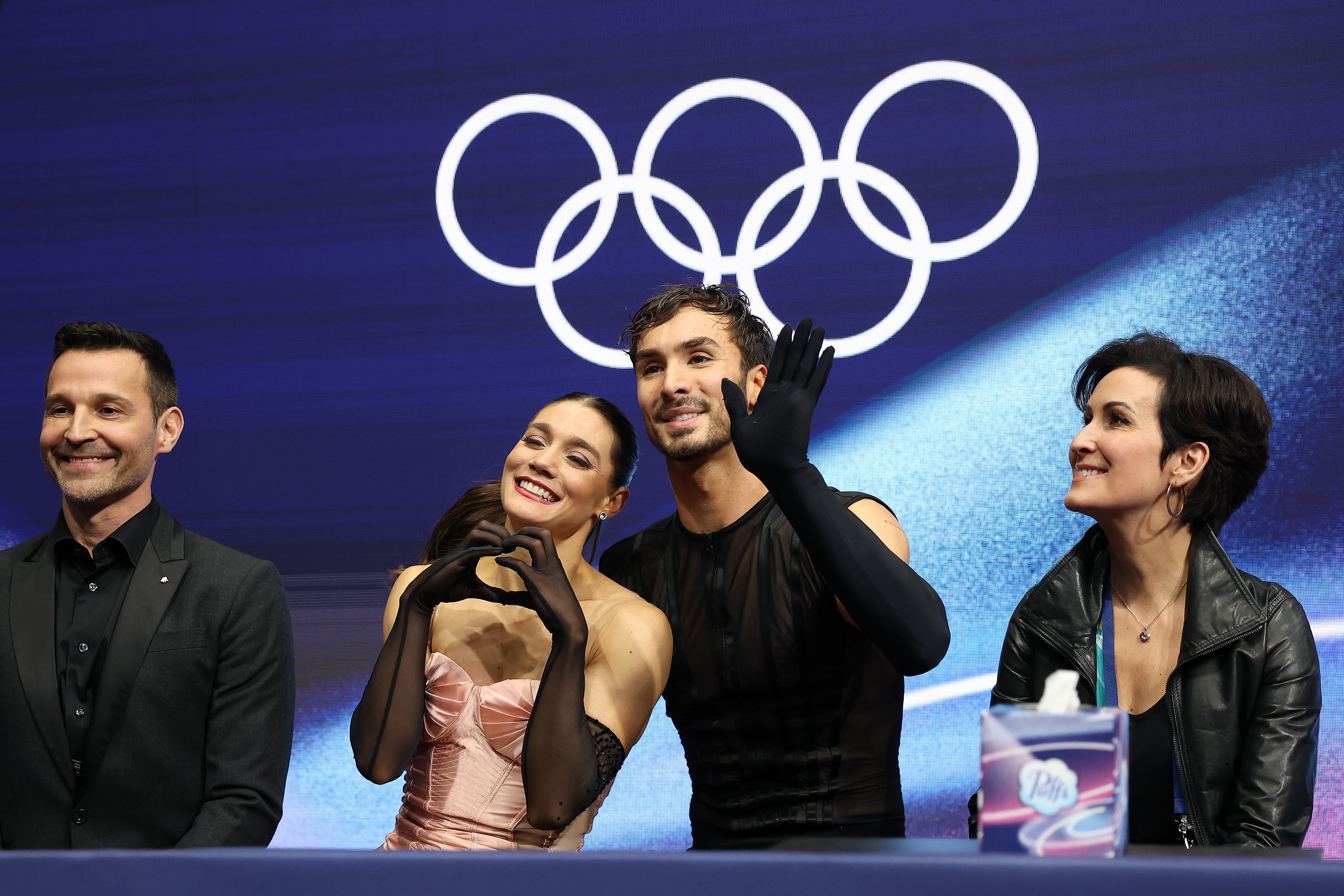 Laurence Fournier Beaudry and partner Guillaume Cizeron of France react with their team in the Kiss and Cry zone