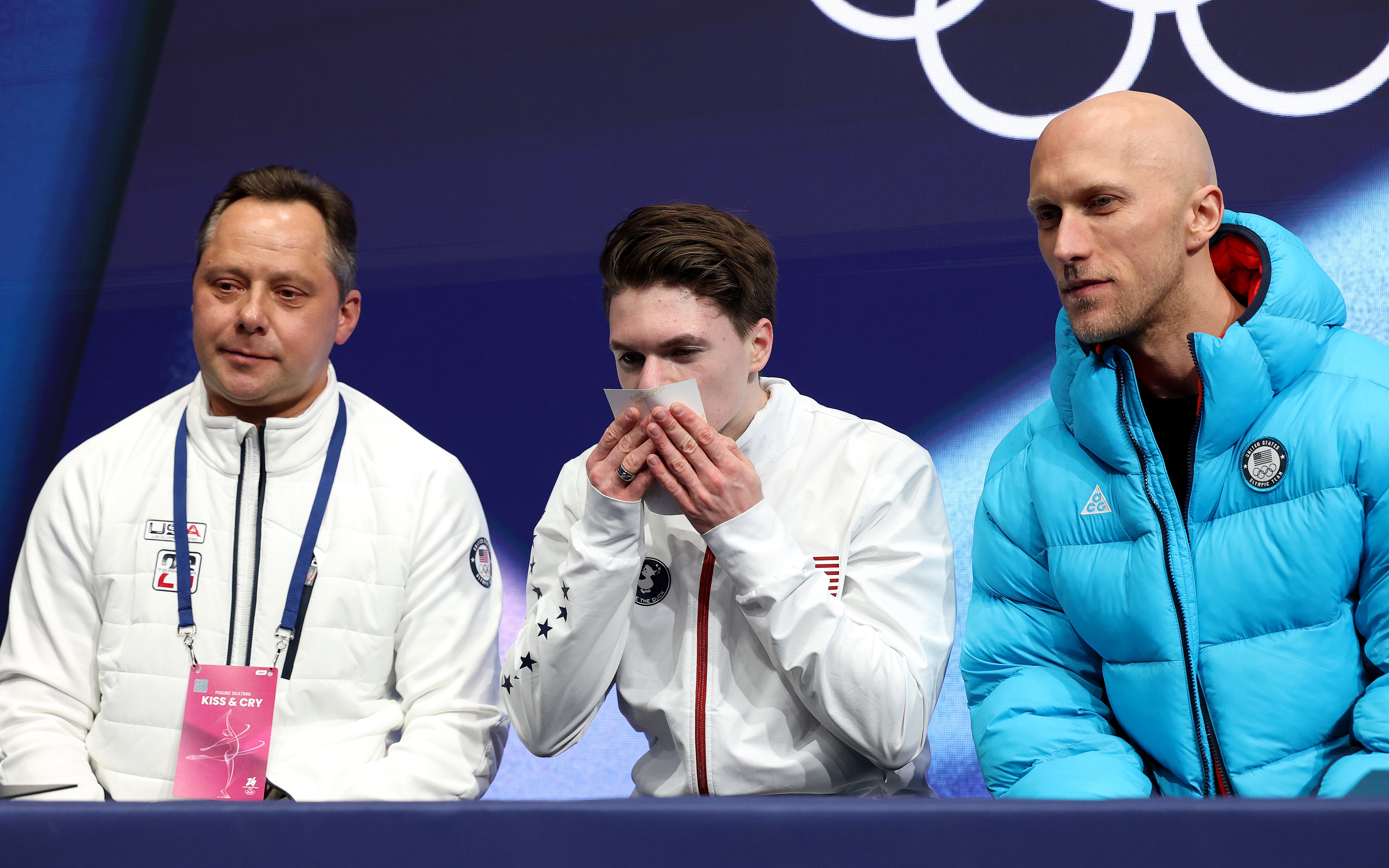 As the 24-year-old awaited his score, he held up a childhood photograph of himself holding hands with his parents, prompting cheers from spectators at the Milano Ice Skating Arena