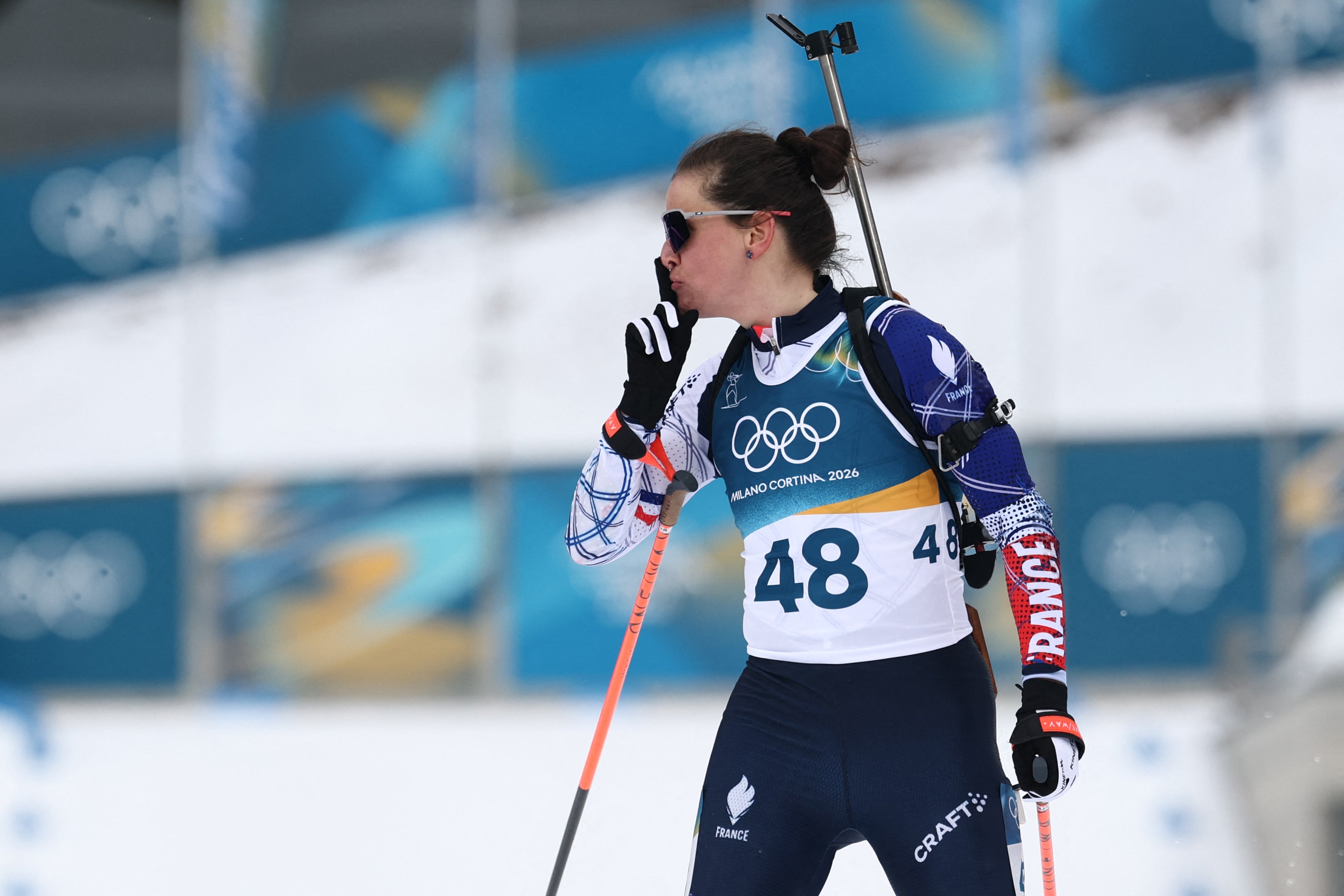 France's Julia Simon gestures after crossing the finish line in the women's biathlon 15km individual event