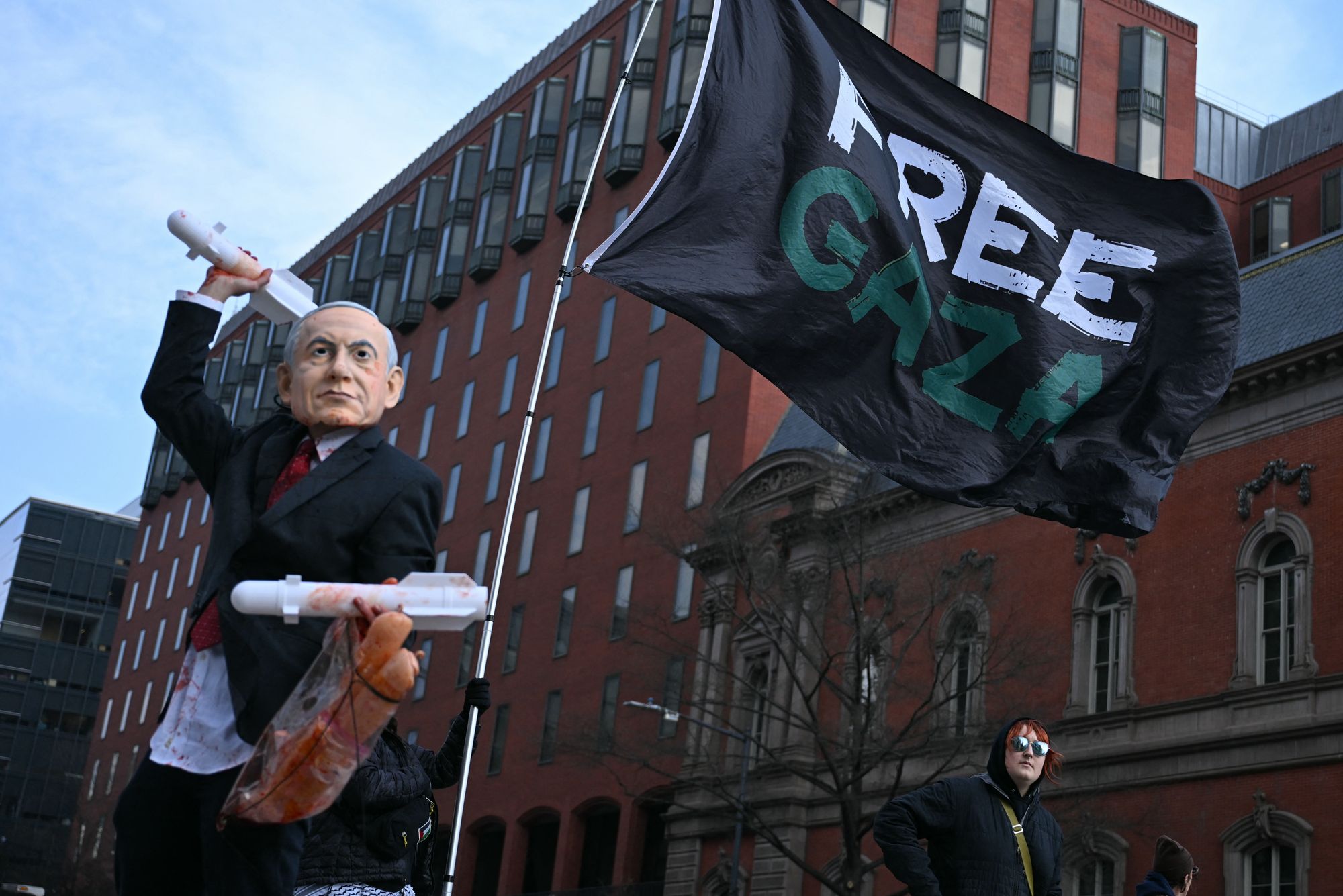 A protester is seen wearing a Benjamin Netanyahu mask near the White House as the Israeli leader met with Trump Wednesday