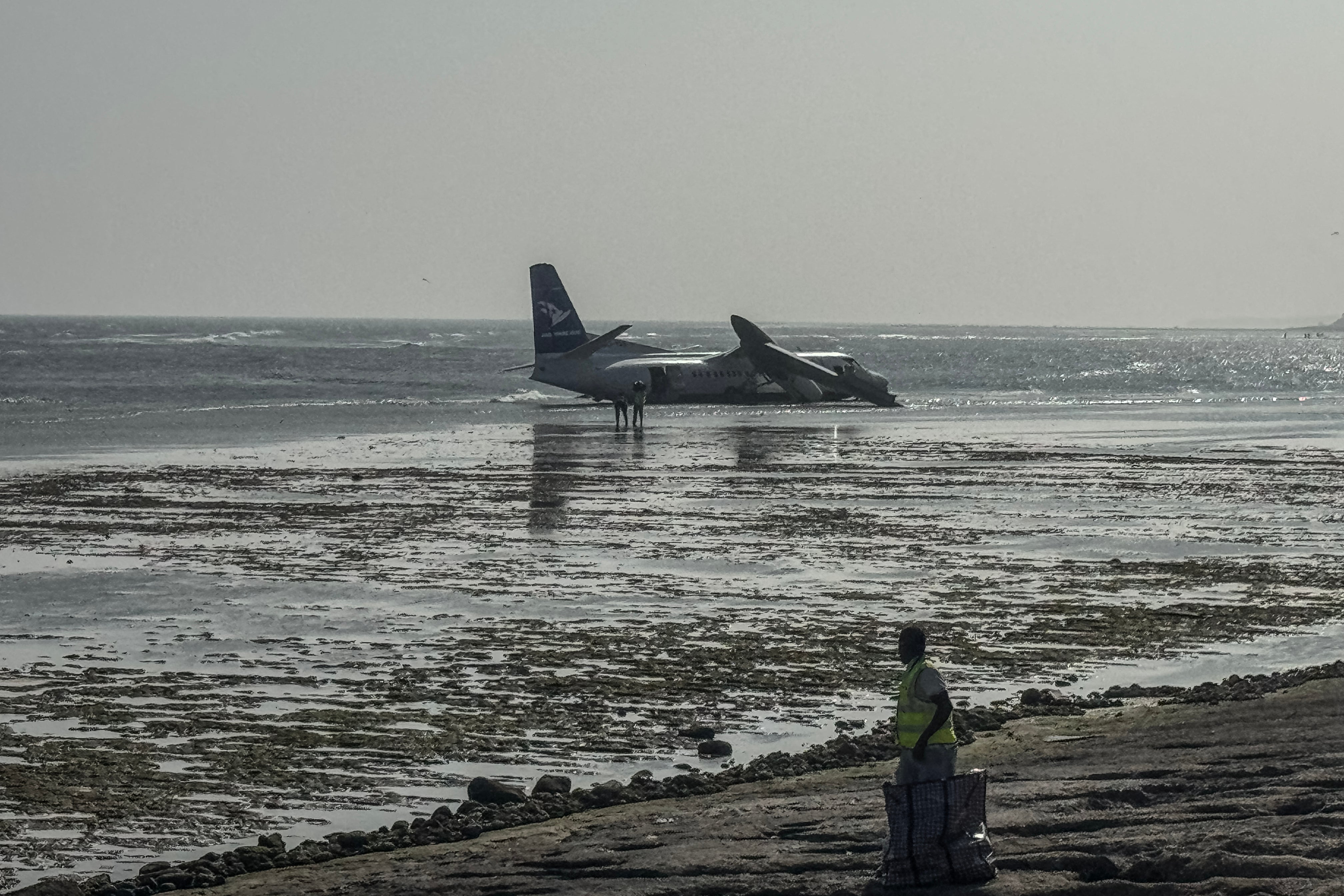 Emergency personnel are seen at the site of the crash of a StarSky airliner after it plunged shortly after taking off with 55 passengers on board in Mogadishu, on 10 February 2026