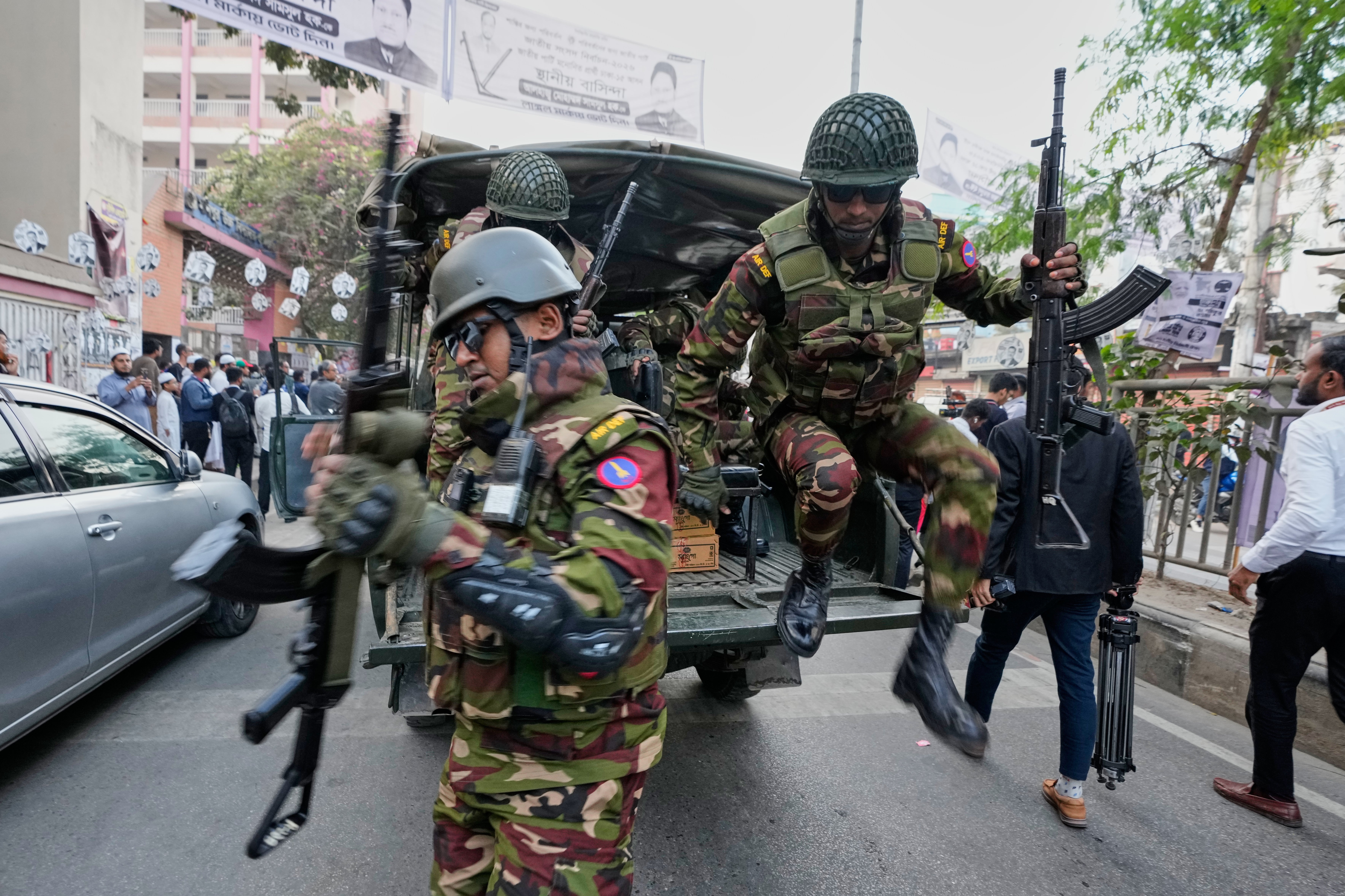 Army personnel jump from a vehicle outside a polling station during national parliamentary election in Dhaka, Bangladesh, Thursday, 12 Feb 2026