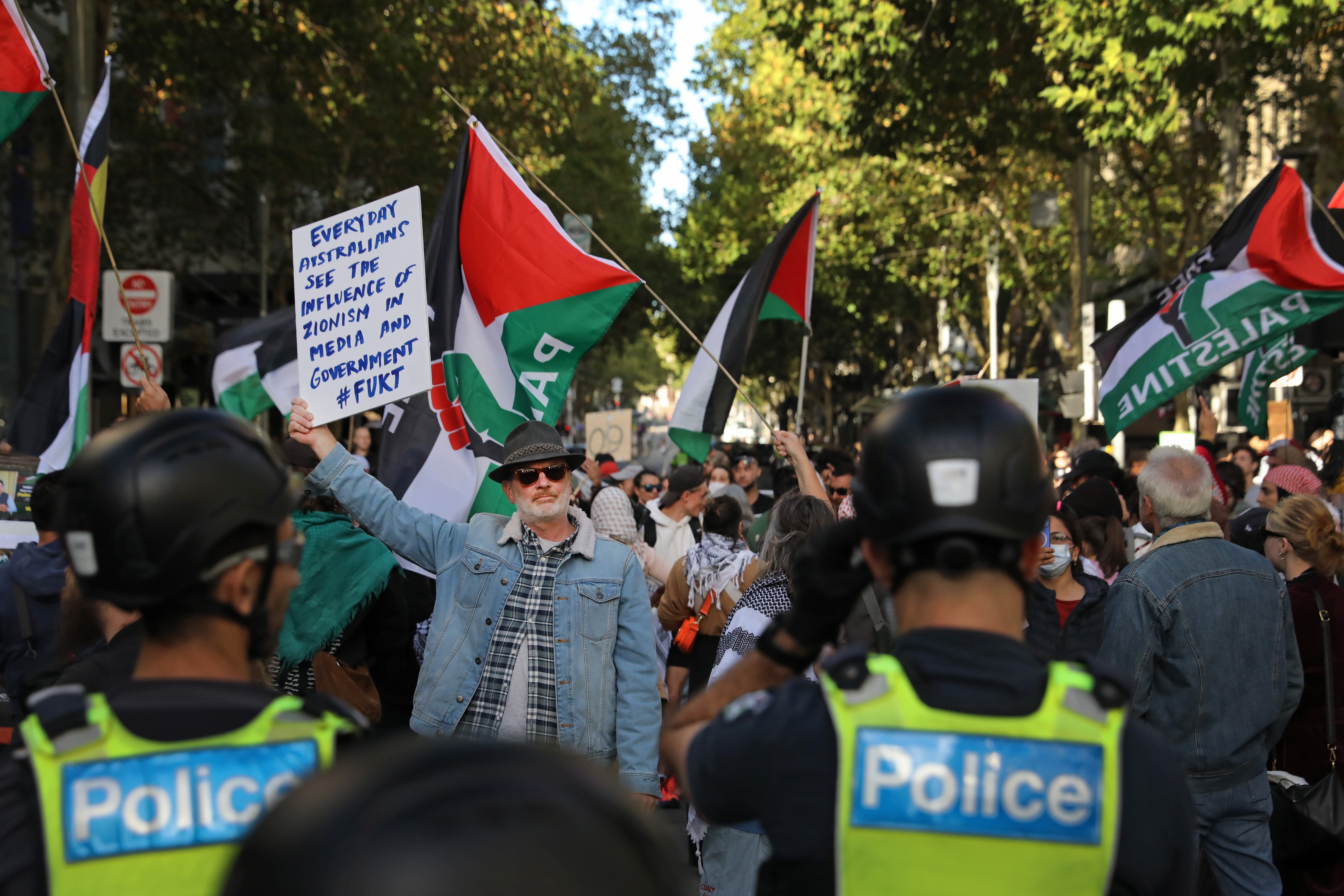 Pro-Palestine supporters march through the central business district (CBD) to protest against the visit of Israel’s president, Isaac Herzog, on 12 February 2026 in Melbourne, Australia