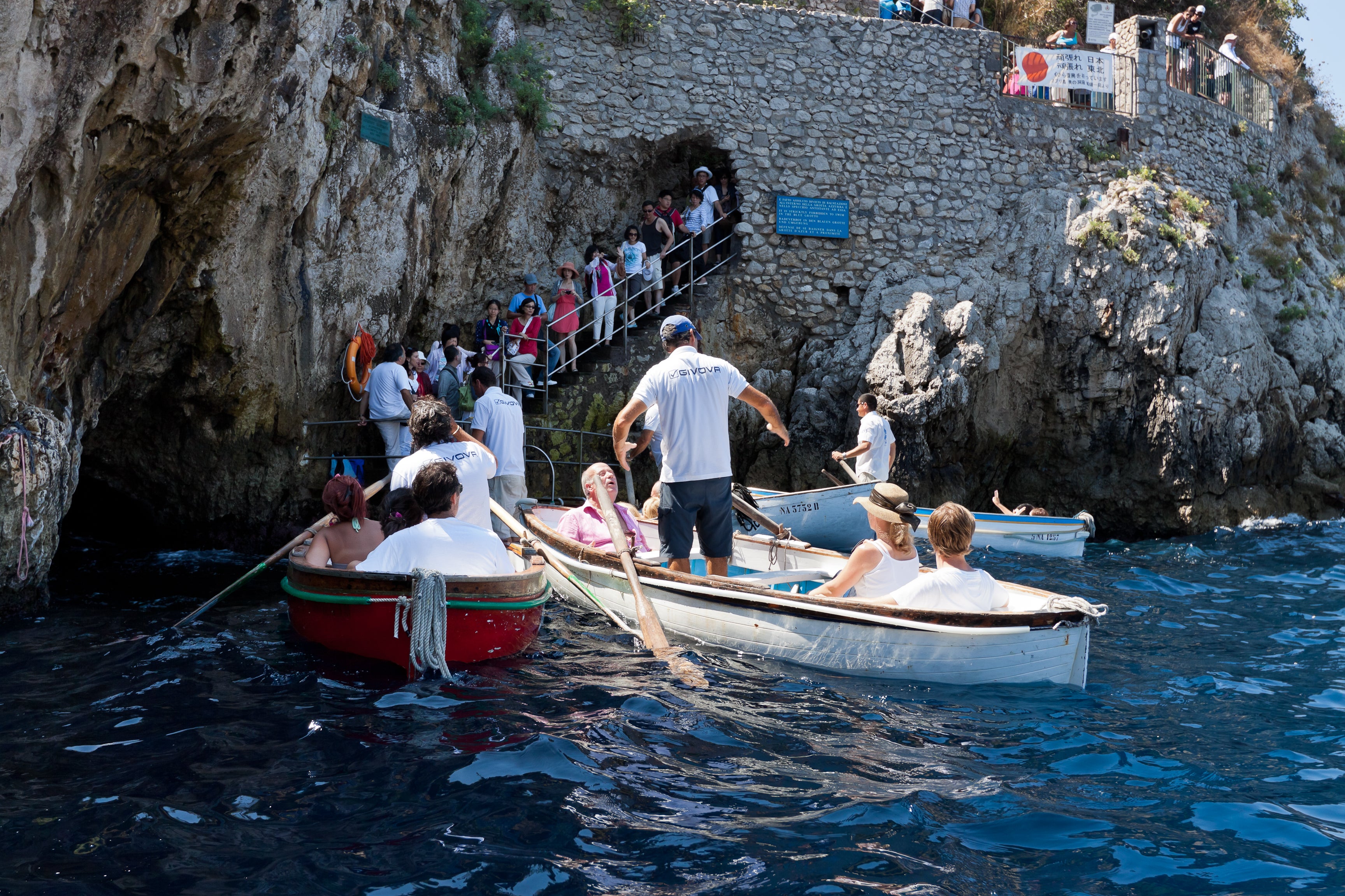 Tourists on board of the small boats waiting to enter the in the famous Blue Grotto of Capri in 2011