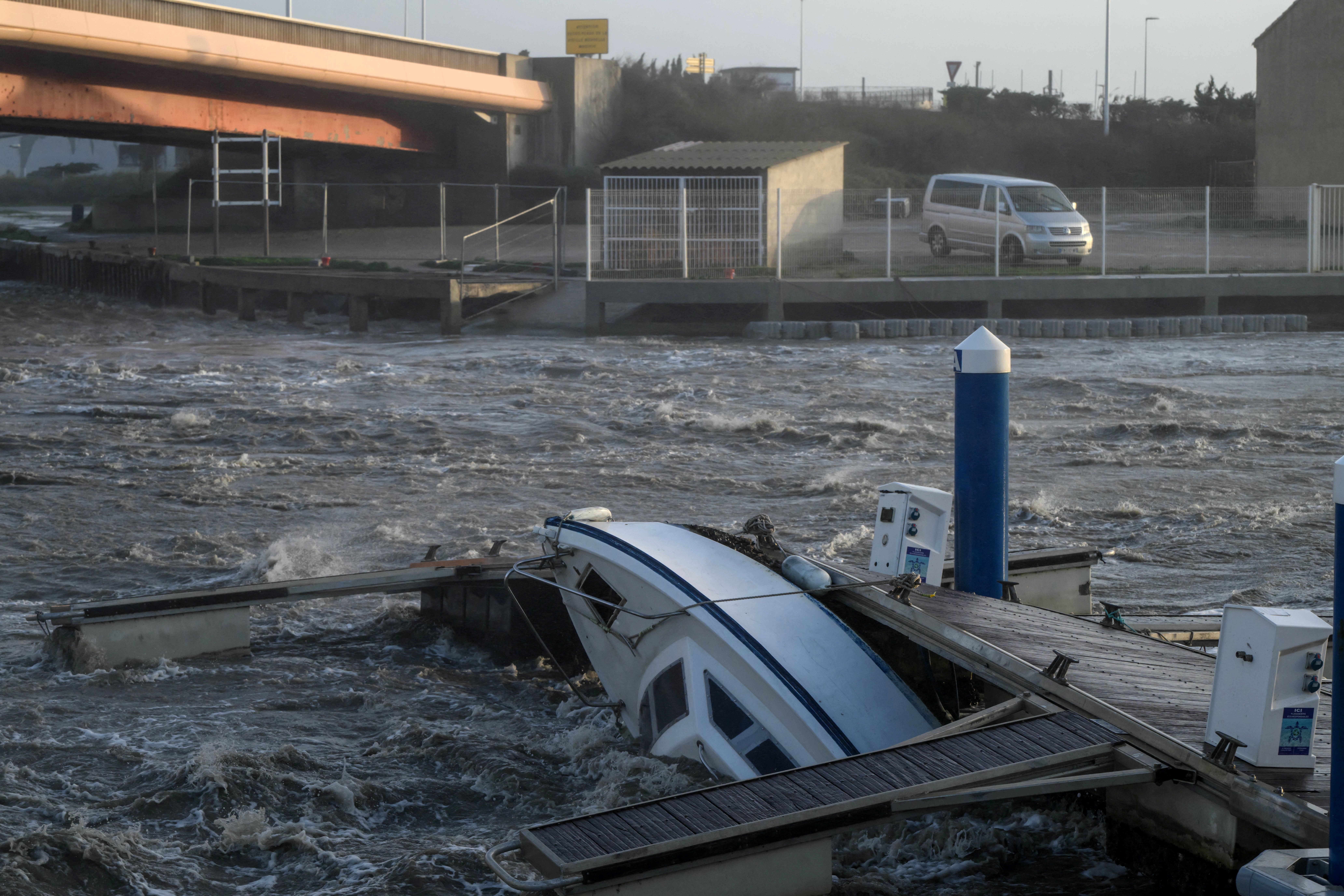 A boat pushed against a jetty by fast-moving water and winds caused by Storm Nils at Port-la-Nouvelle near Narbonne, on Thursday