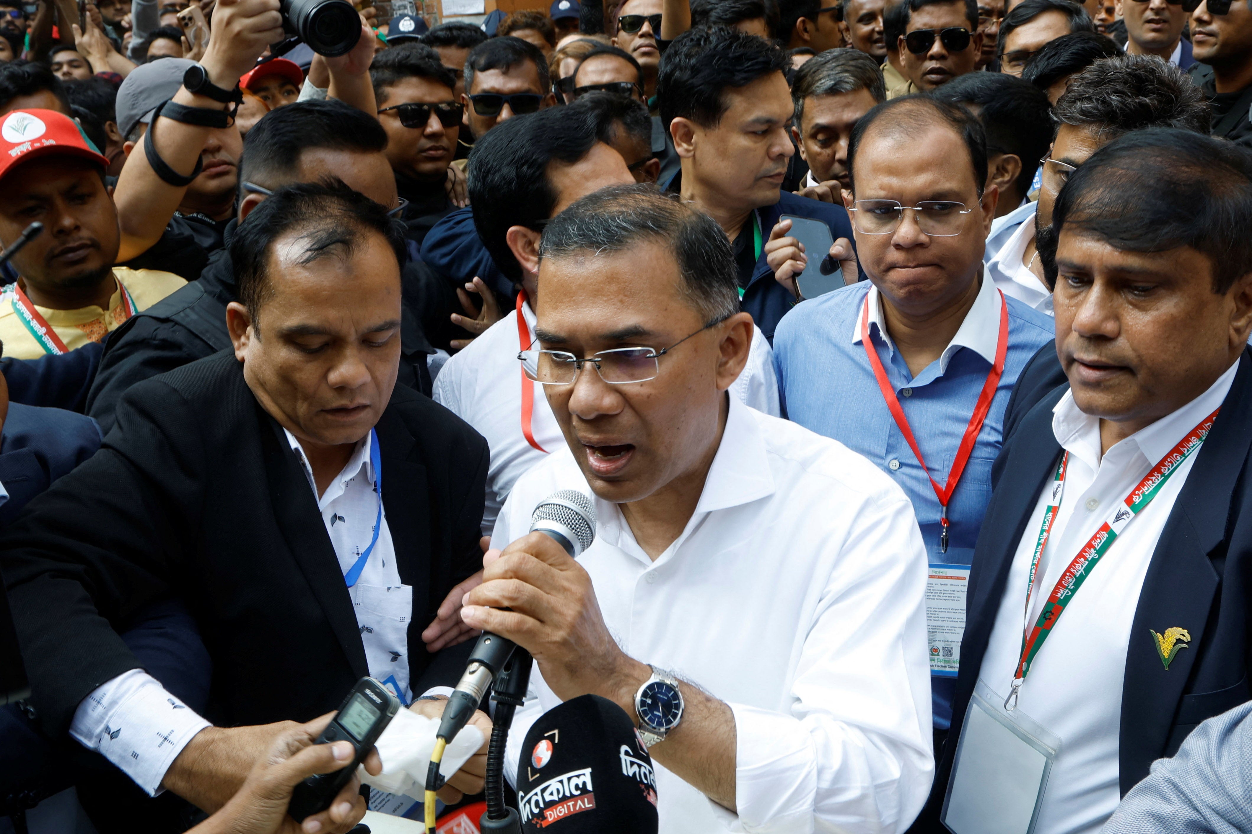 Tarique Rahman speaks with the media after voting outside a polling station.