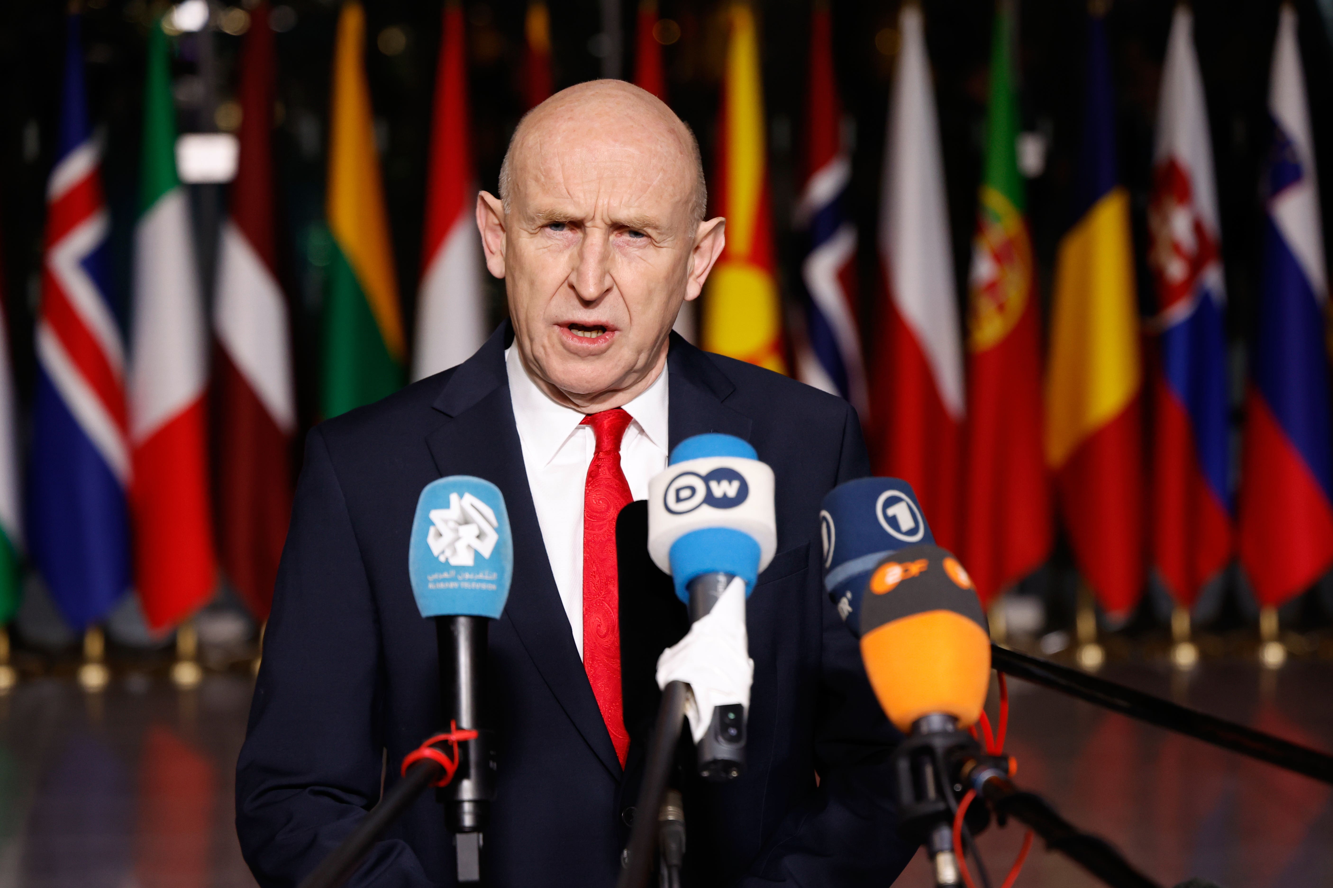 John Healey speaks with the media in Brussels (Geert Vanden Wijngaert/AP)