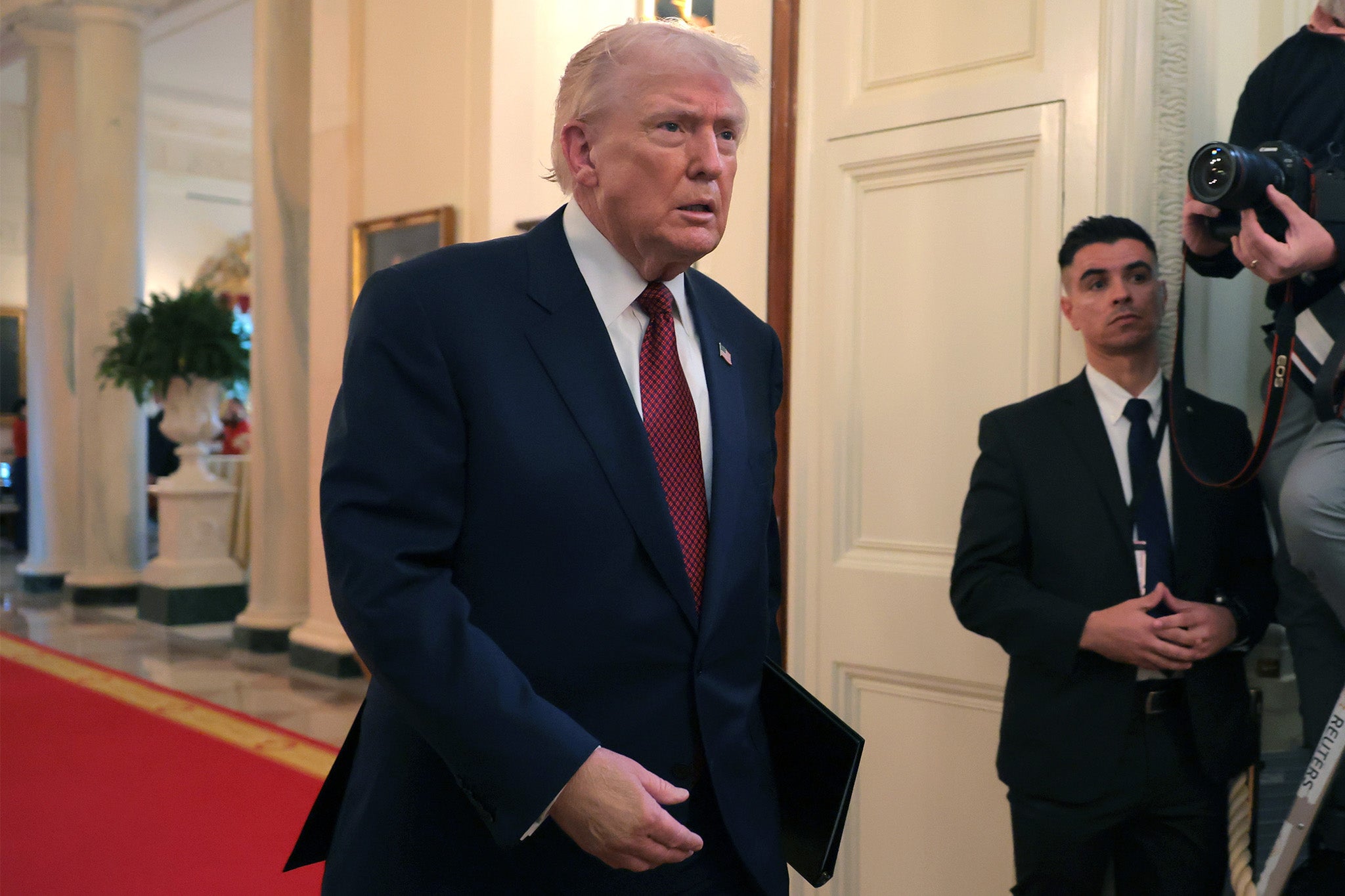 U.S. President Donald Trump arrives for an event on the use of coal in the East Room of the White House on February 11, 2026 in Washington, DC. Makeup on his right hand appears to be covering a a bruise