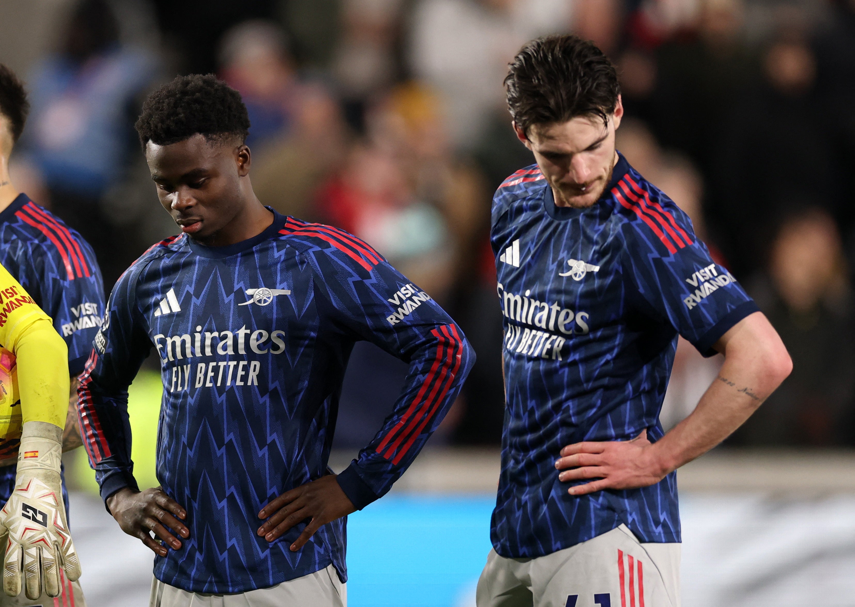 Arsenal's Bukayo Saka and Declan Rice look dejected after Brentford's Keane Lewis-Potter scores