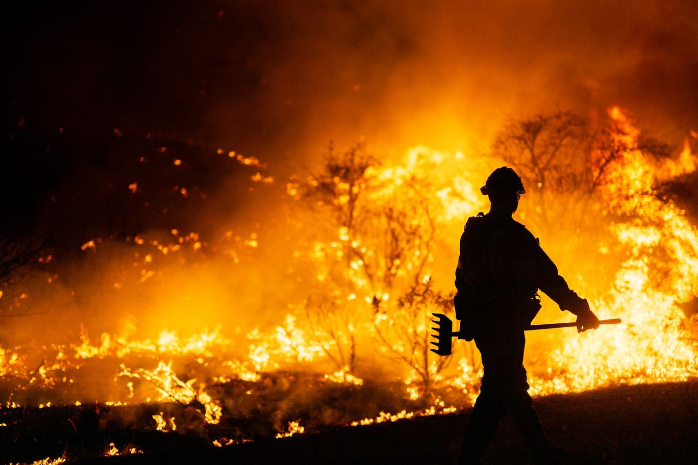 A firefighter is surrounded by wildfire flames in Southern California in January 2025