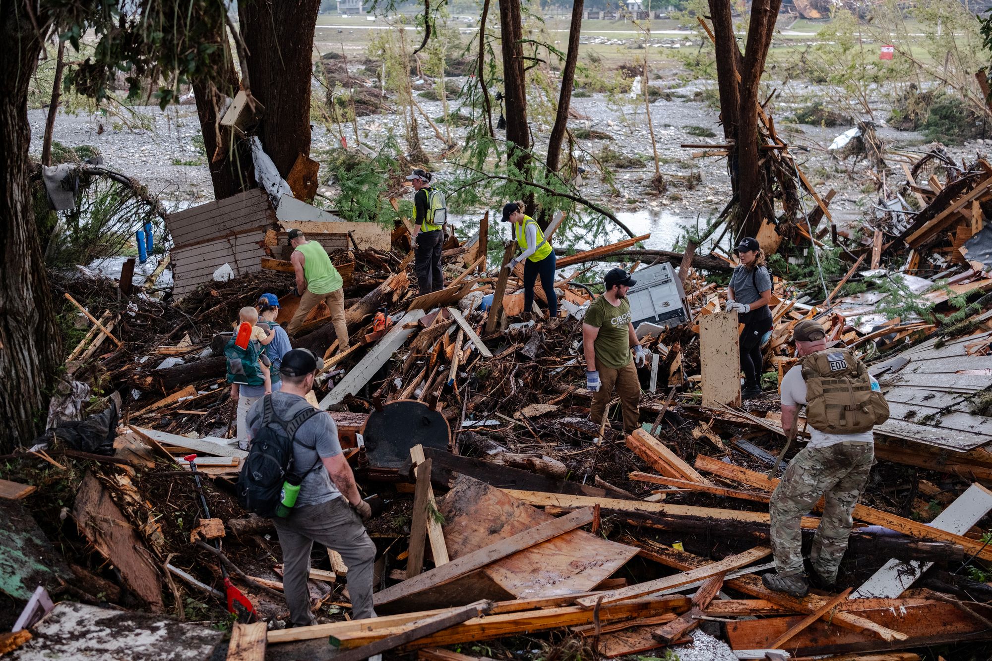 Search and rescue workers dig through debris in Hunt, Texas, after deadly flooding last July. A warming atmosphere is making storms more rain-heavy