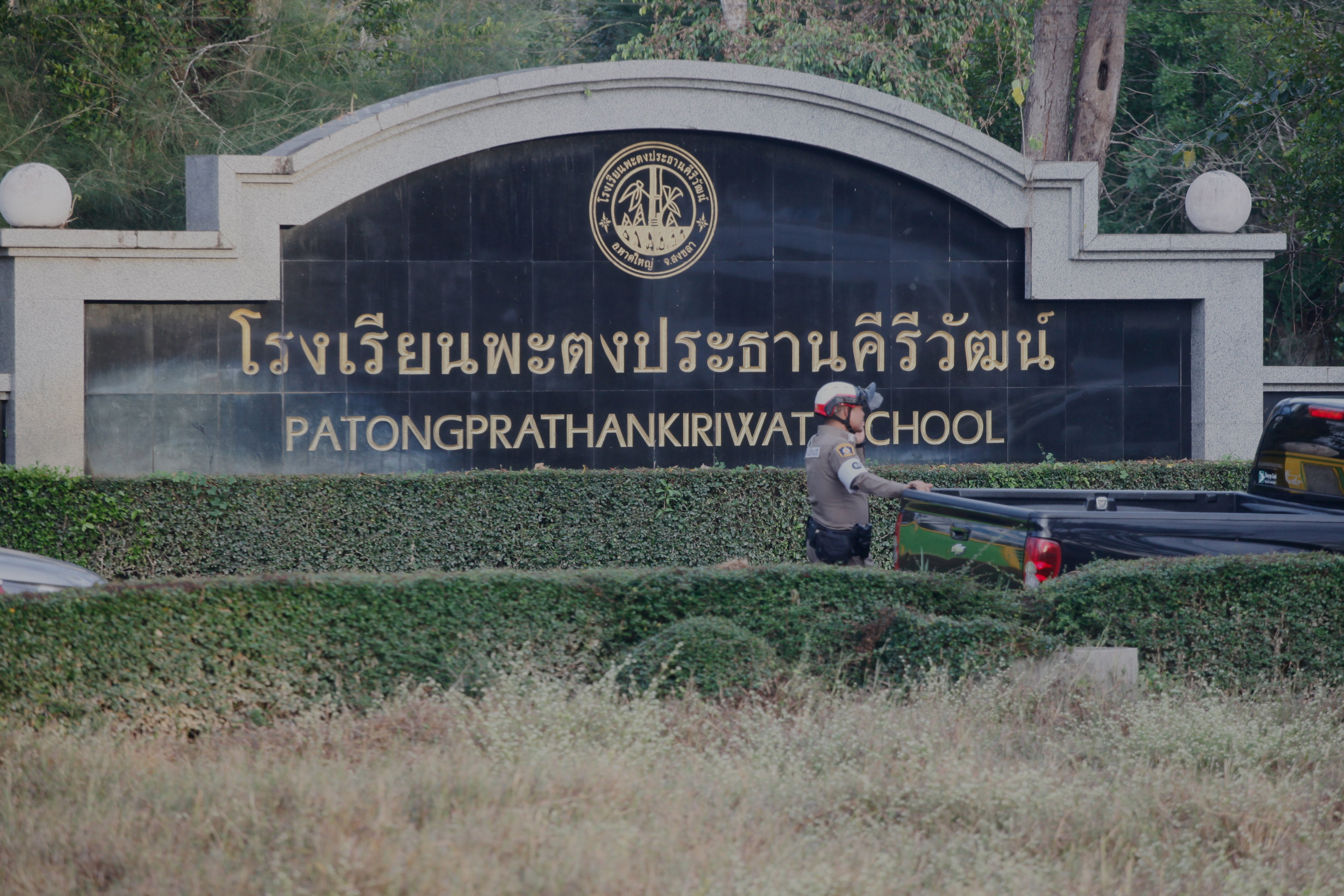 A Thai policeman stands outside Patongrathankiriwt school at Hat Yai, southern Thailand, Wednesday, 11 February 2026