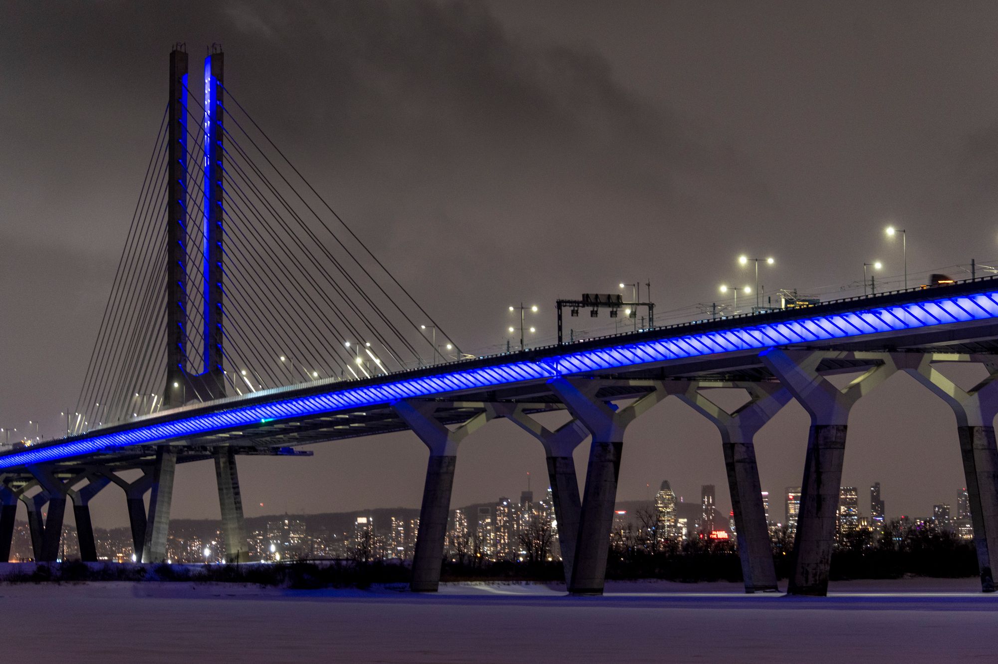 The Samuel De Champlain Bridge in Montreal was lit purple Wednesday to honor the eight victims of the mass shooting in Tumbler Ridge