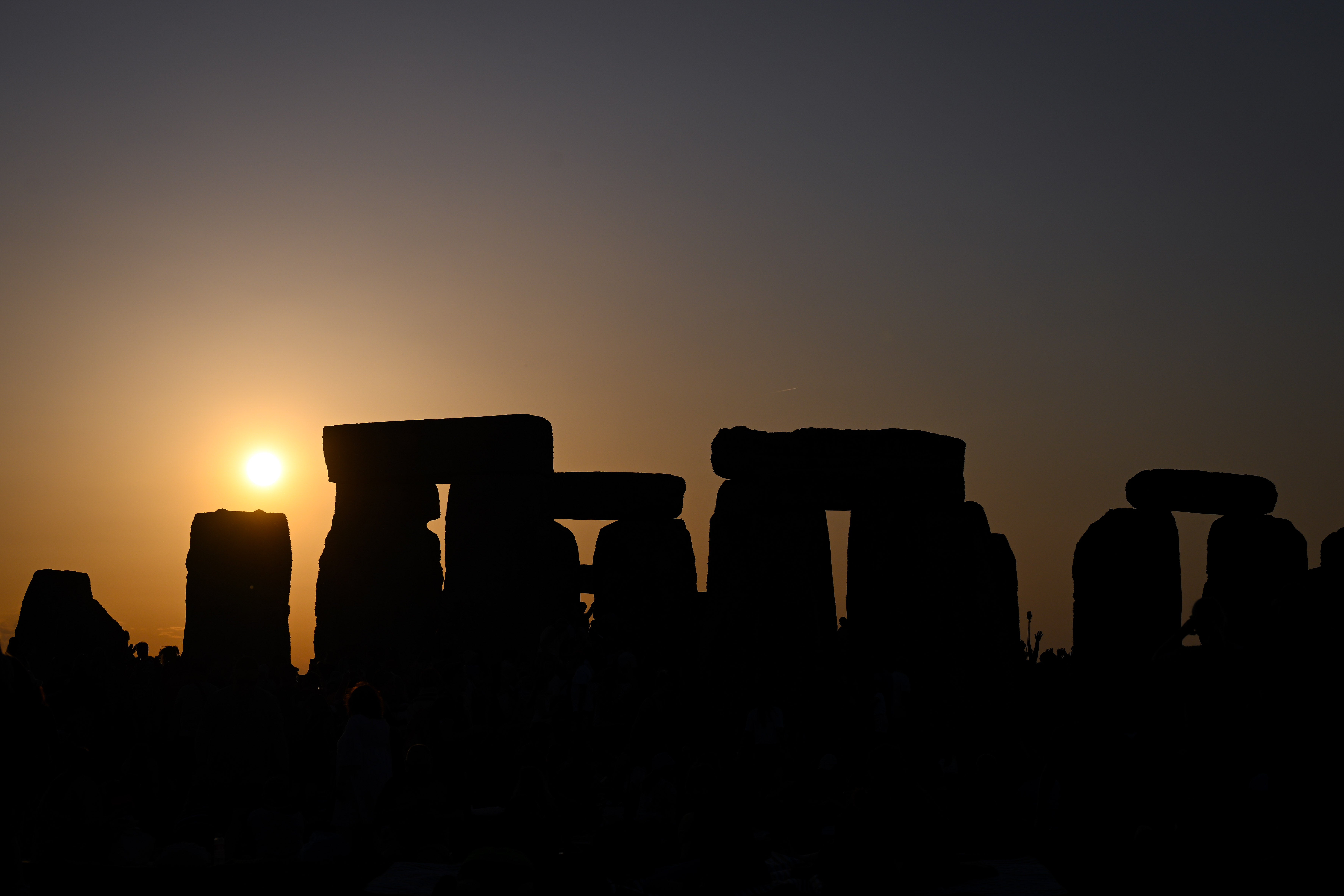The sun sets at Stonehenge during celebrations of the summer solstice
