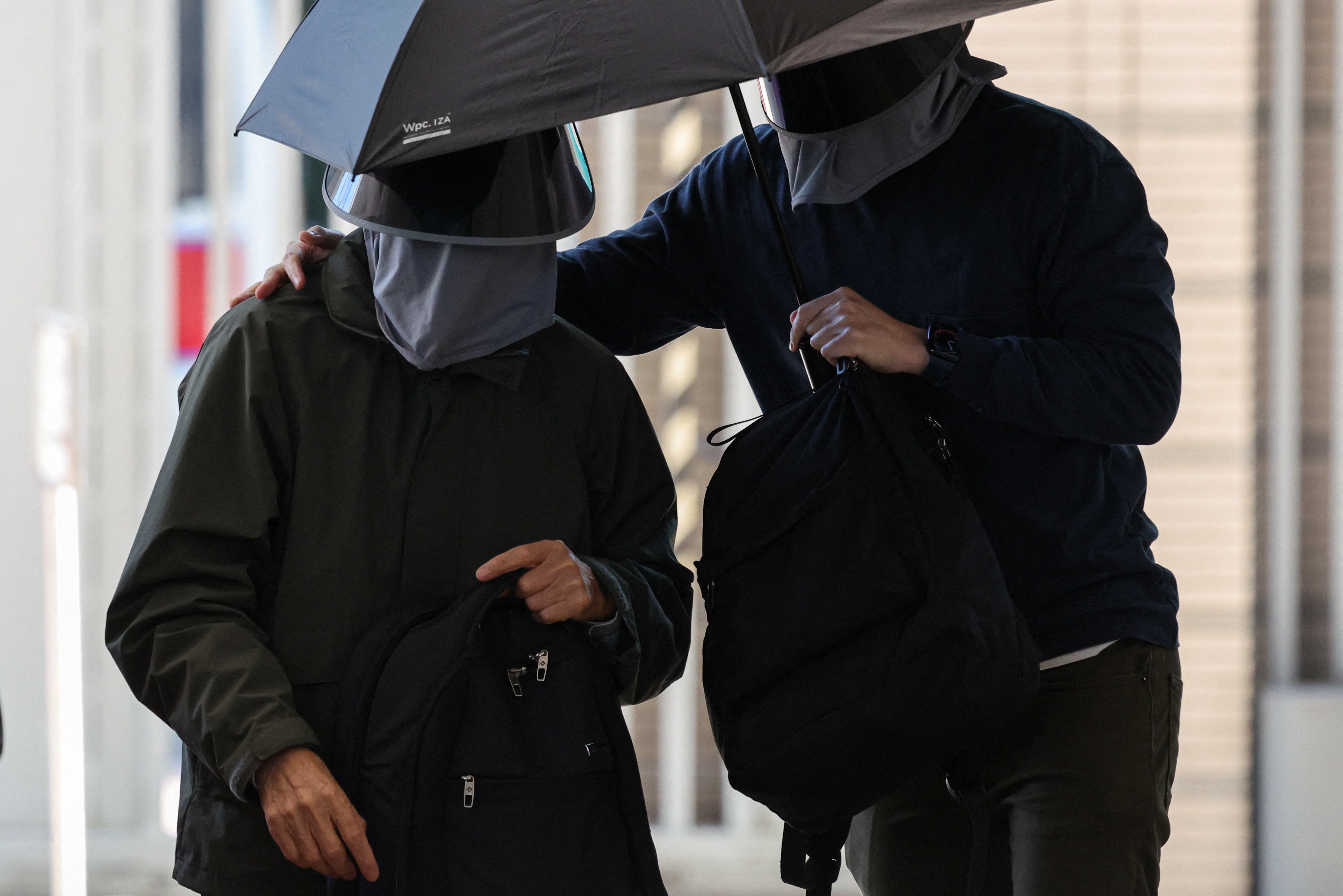 Kwok Yin-sang, father of wanted U.S.-based activist Anna Kwok, arrives at the West Kowloon Magistrates Courts building in Hong Kong, China