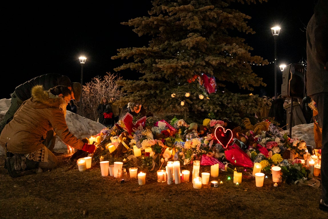 Flowers at a memorial during a candlelight vigil for the victims of Tumbler Ridge Secondary School where a mass shooting took place a day earlier