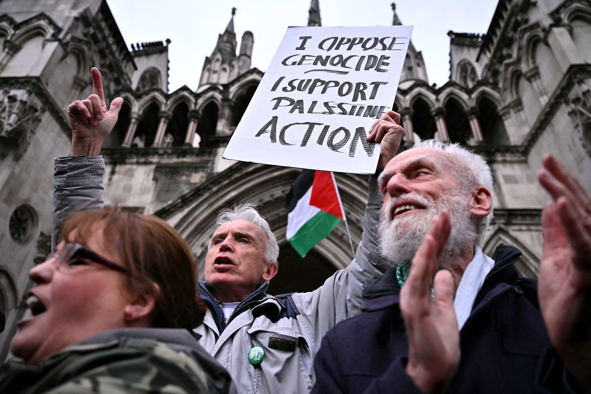 Protesters react after hearing the verdict outside the Royal Courts of Justice, Britain’s High Court, in London on 13 February 2026