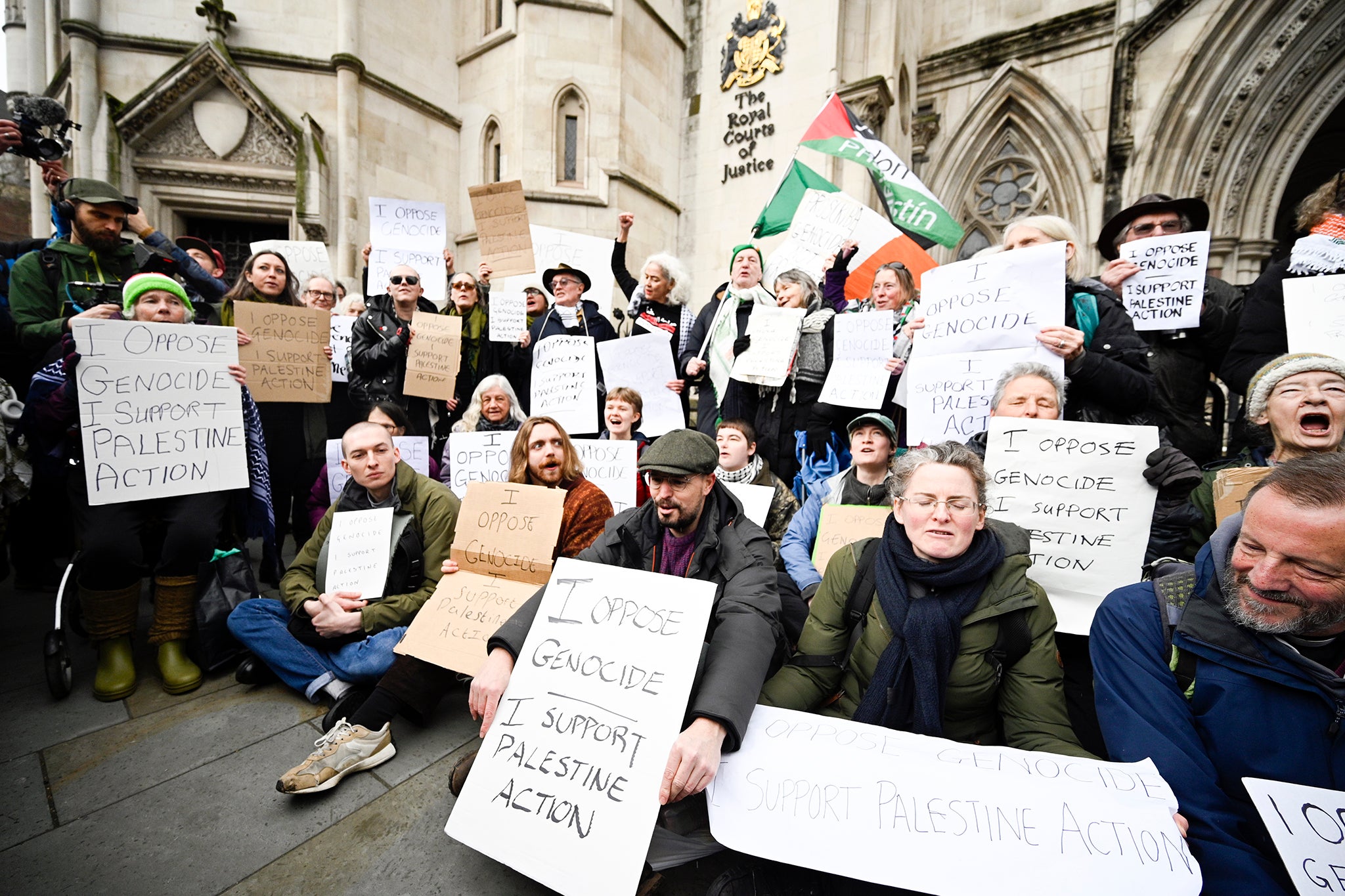 Dozens gathered holding placards and chanting