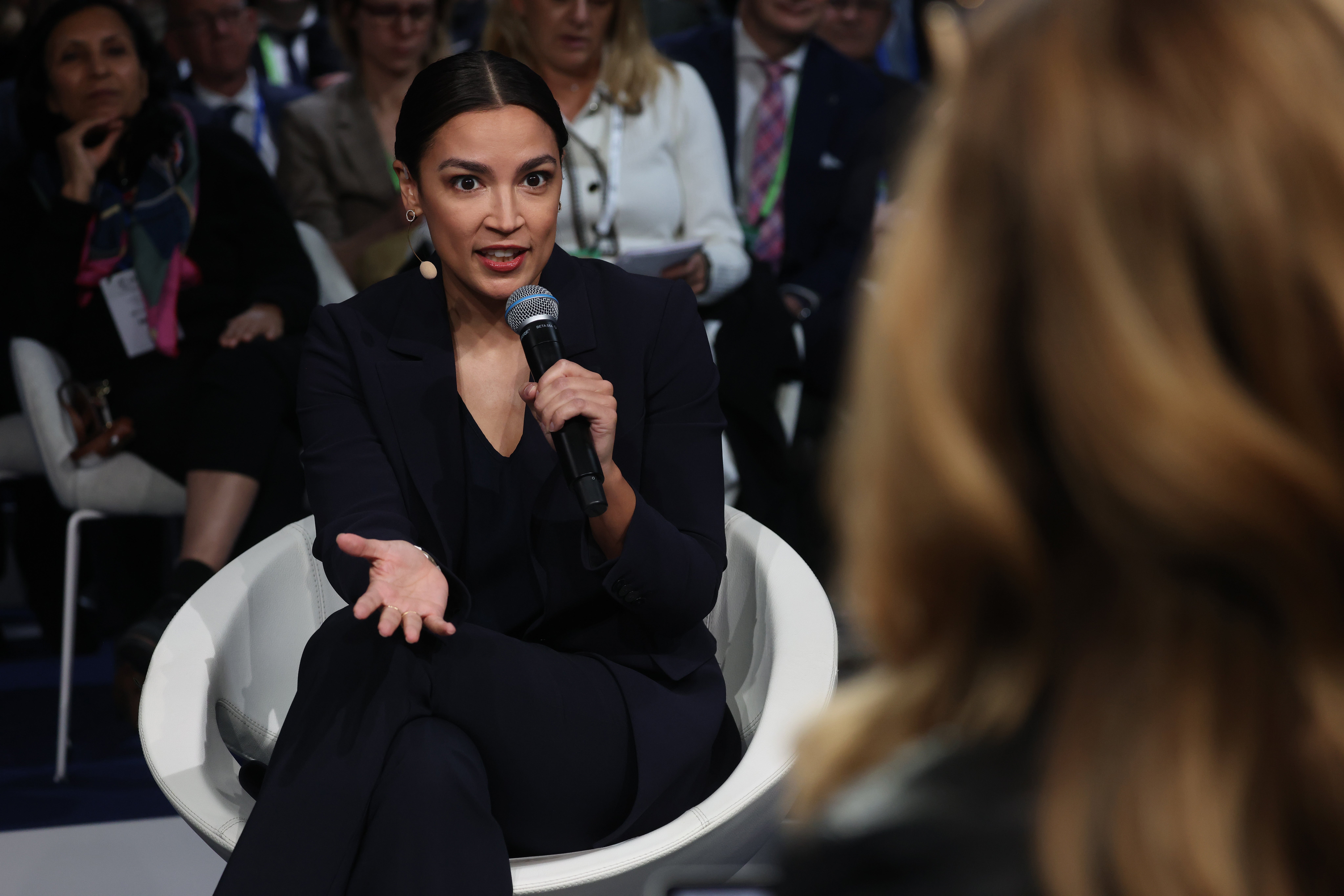Asked at a panel in Munich, “So when you run for president, are you going to impose a wealth tax or a billionaire's tax?” Ocasio-Cortez responded coyly.