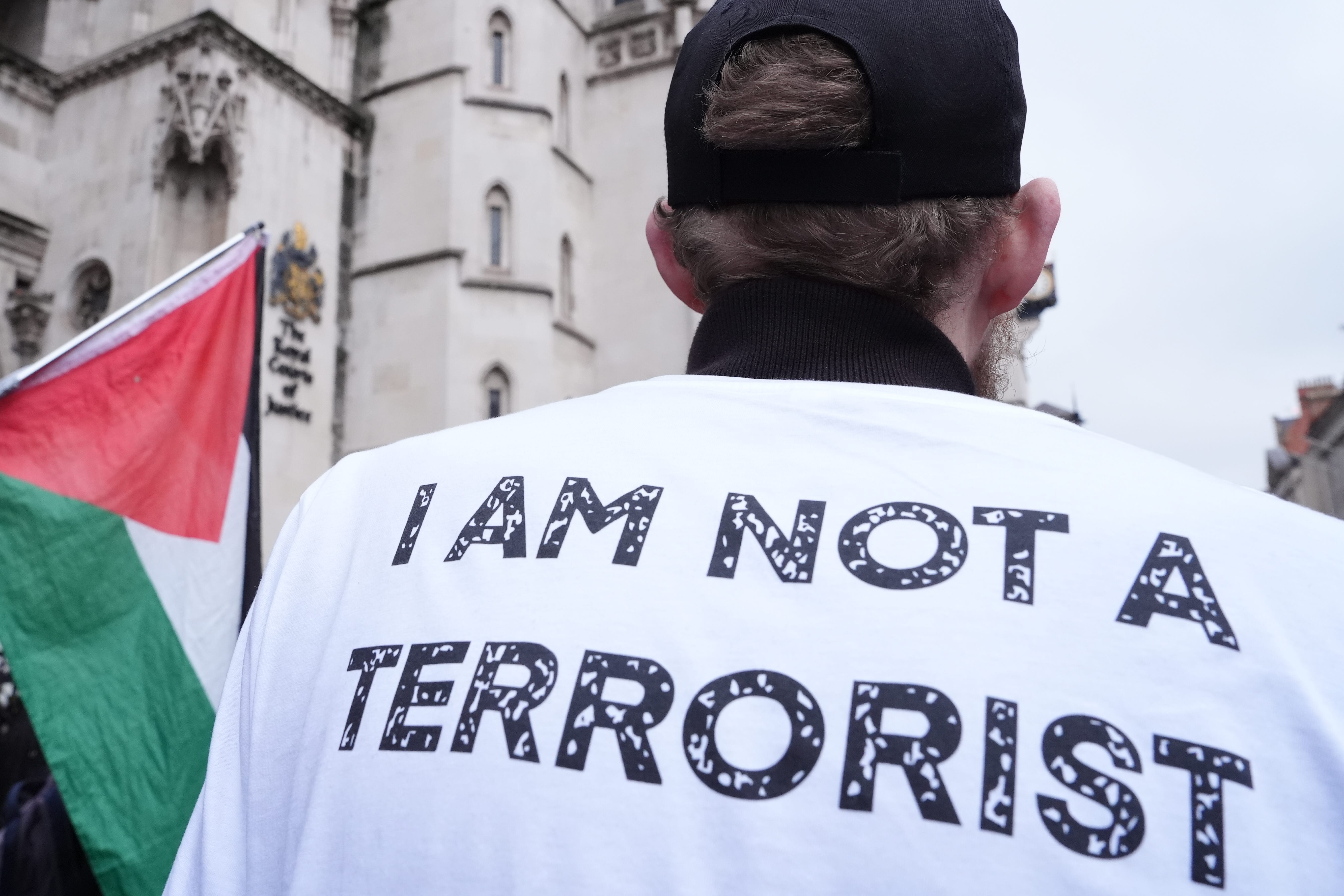 A protester outside the High Court, central London, where Dame Victoria Sharp, Mr Justice Swift and Mrs Justice Steyn have ruled in favour of Palestine Action’s co-founder Huda Ammori’s challenge over the ban of the organisation as a terror group (Jonathan Brady/PA)