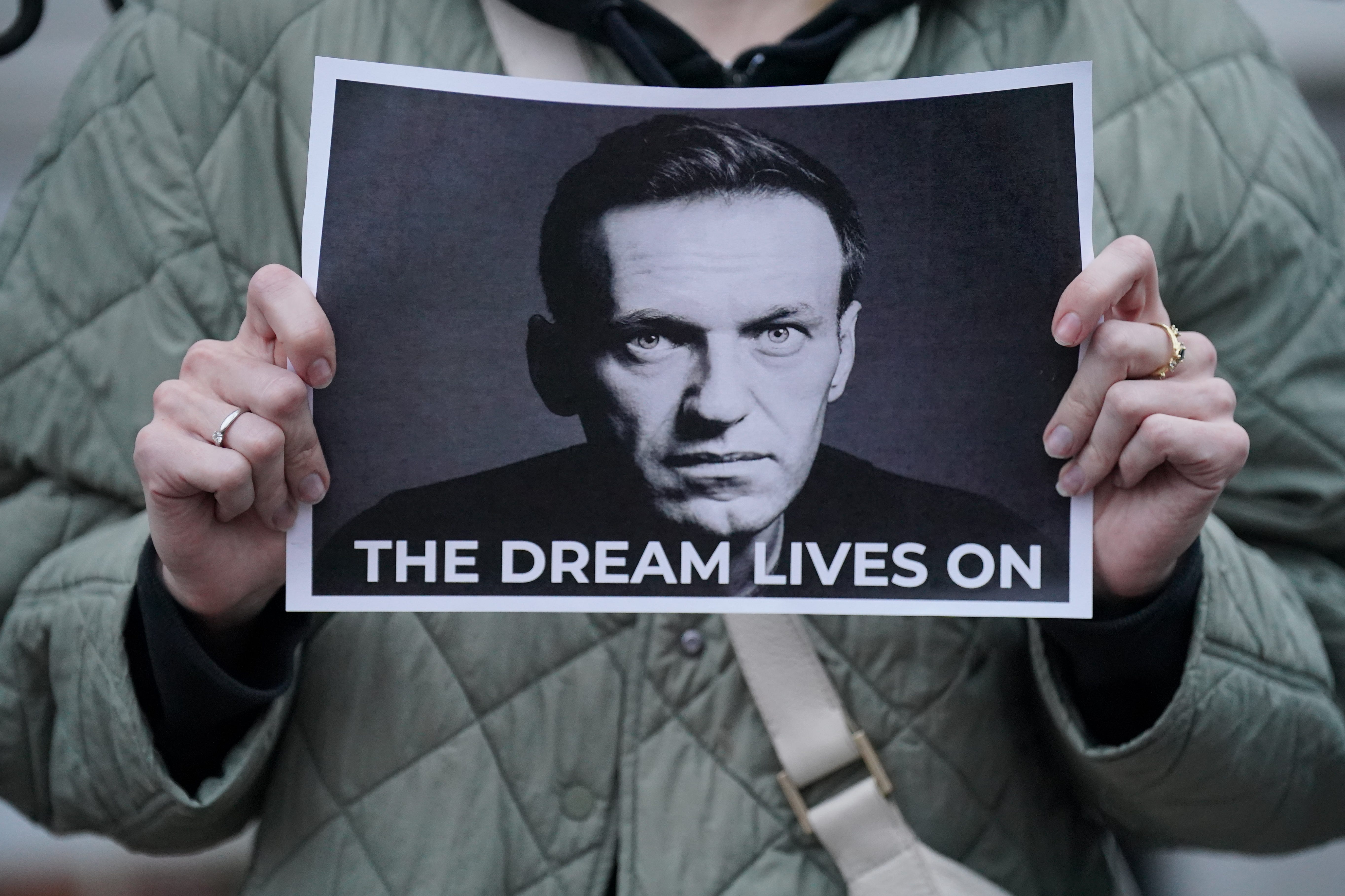 A protester holding a picture of Alexei Navalny at a protest opposite the Russian Embassy in London in 2024
