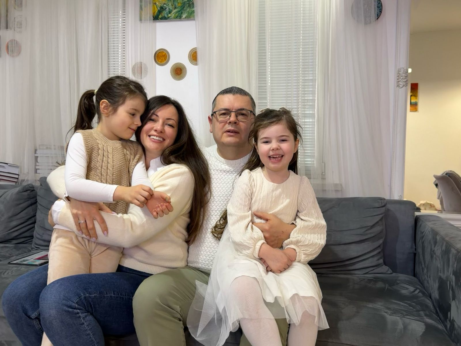 Sophia, age four, pictured right with her seven-year-old sister Lilian, mother and father