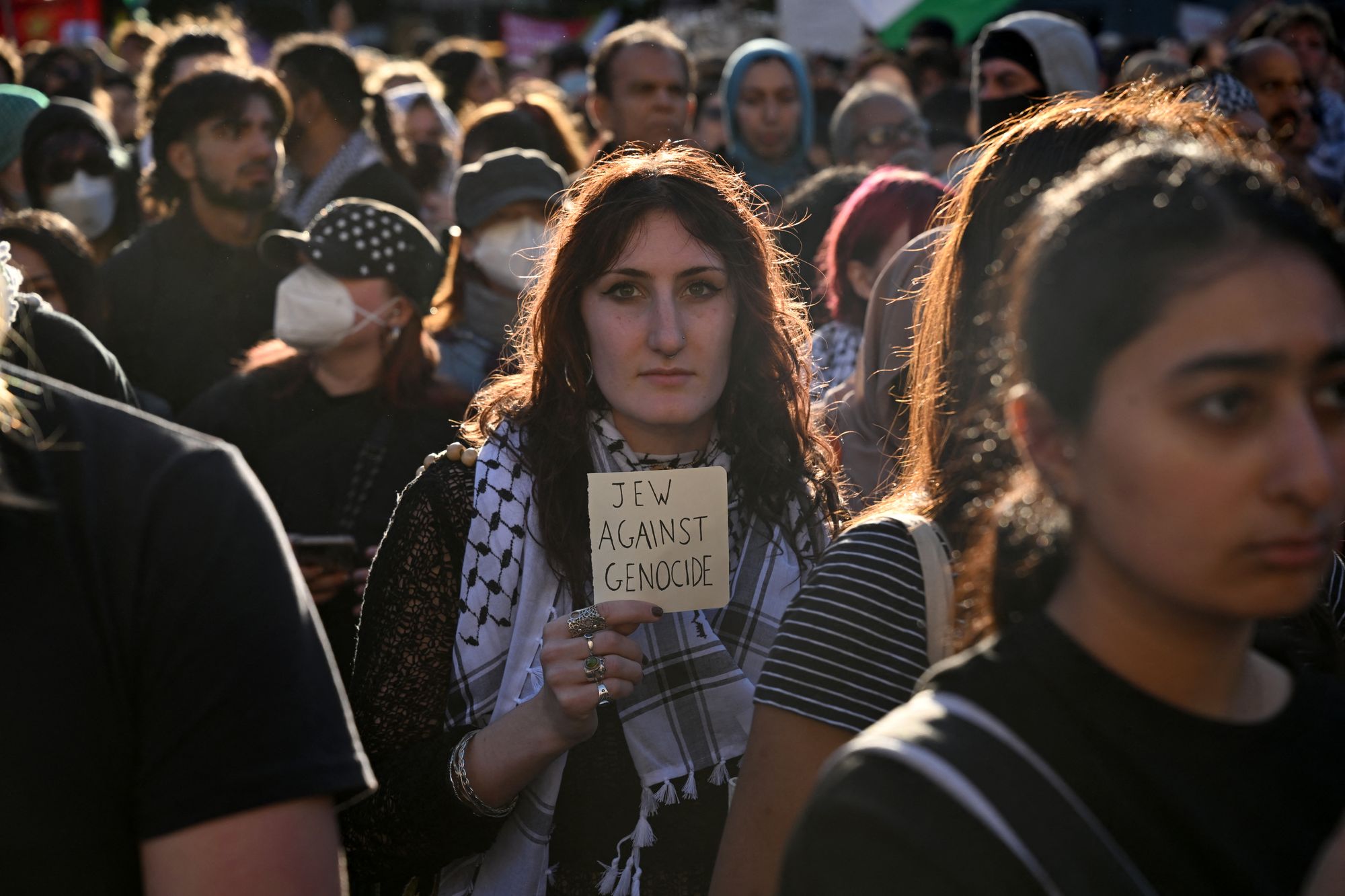 A woman holds up a sign while marching in Melbourne